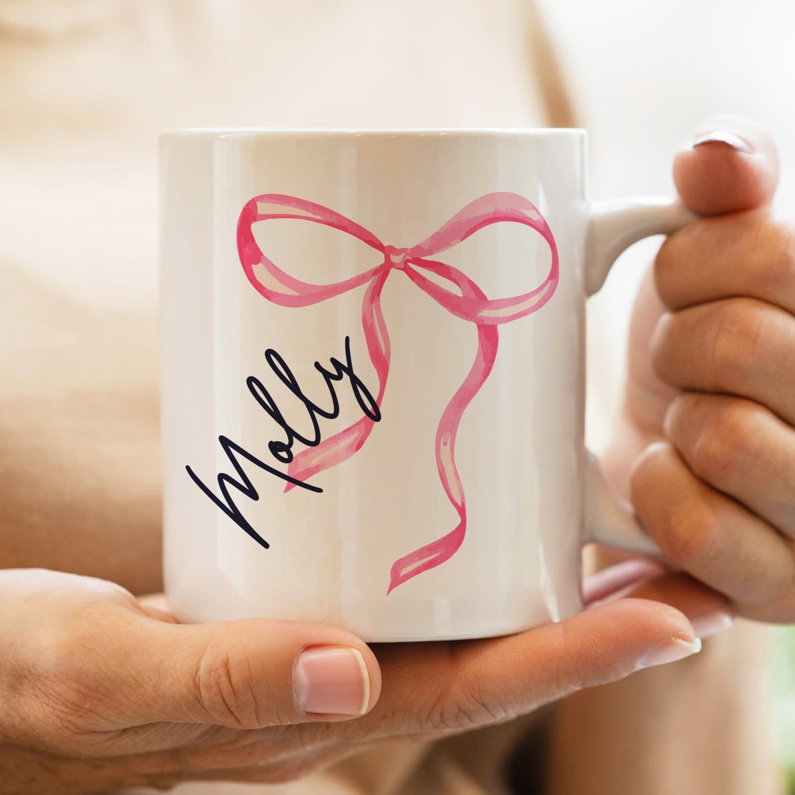 Ceramic mug with a bow design and a personalised name