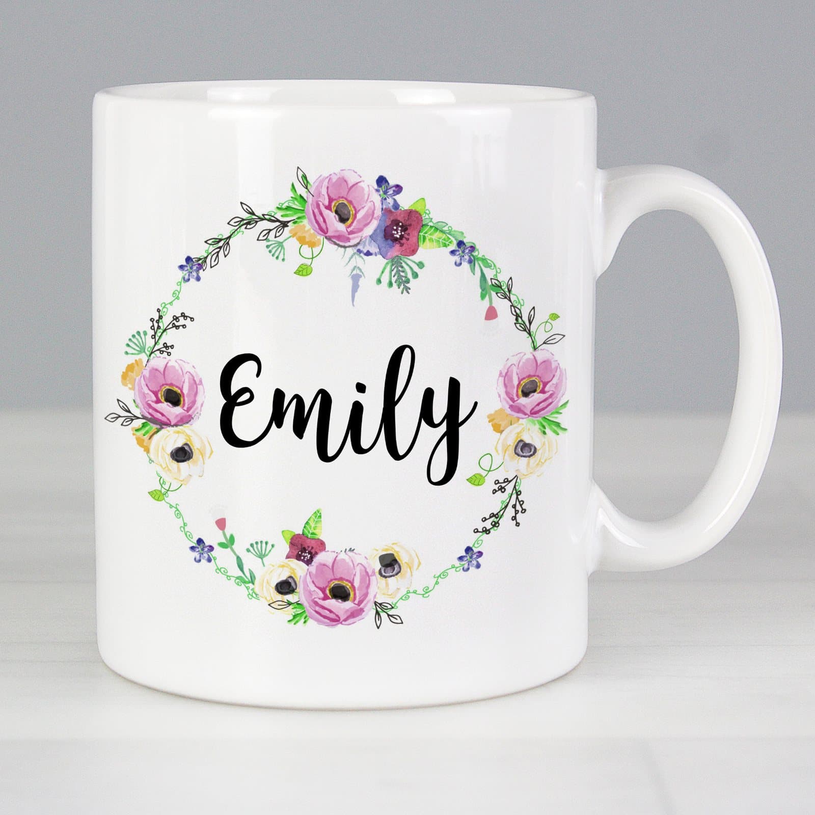 Personalised ceramic mug with a floral design, shown in floral and blue styles