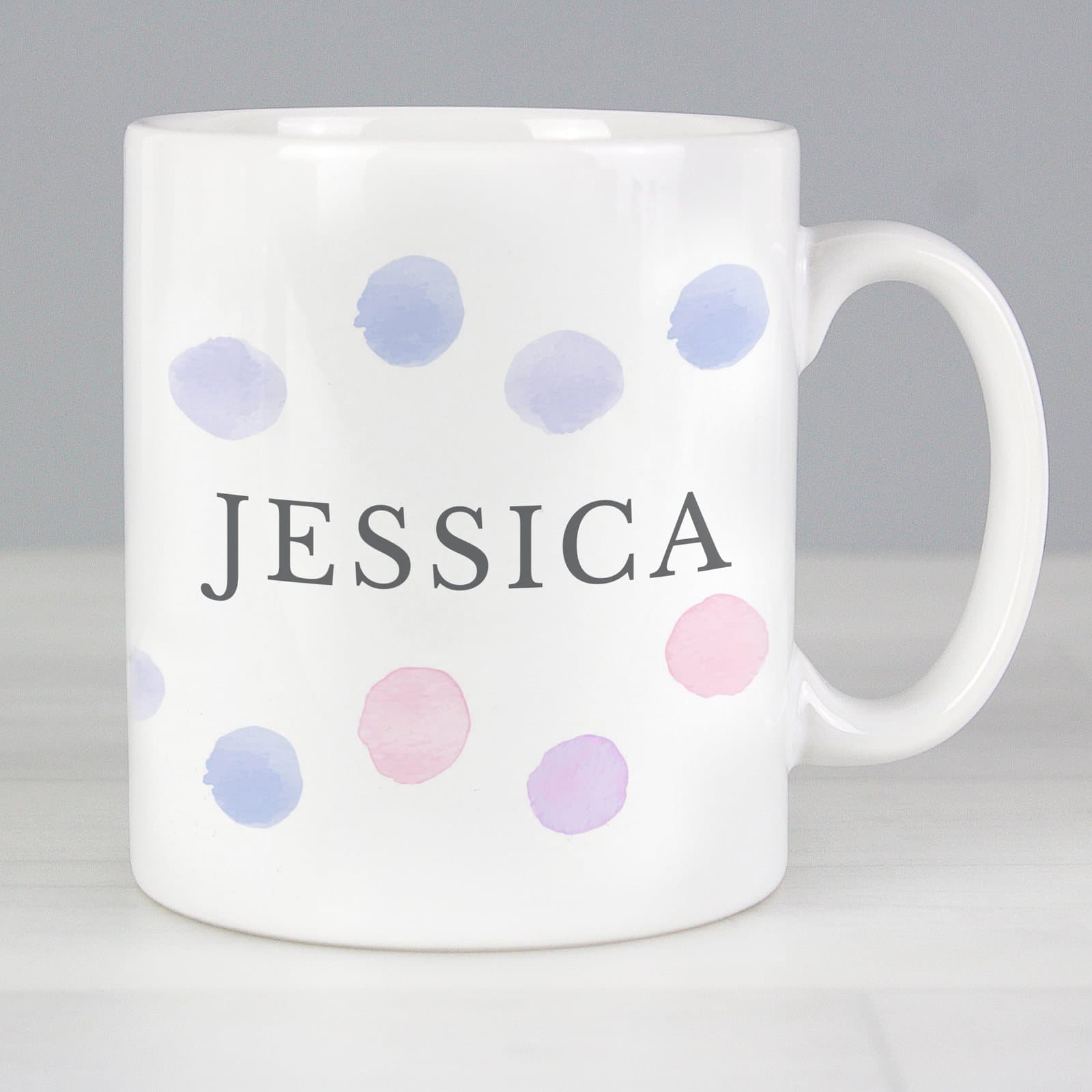 Personalised ceramic mug with a watercolour dotty design in pink or blue