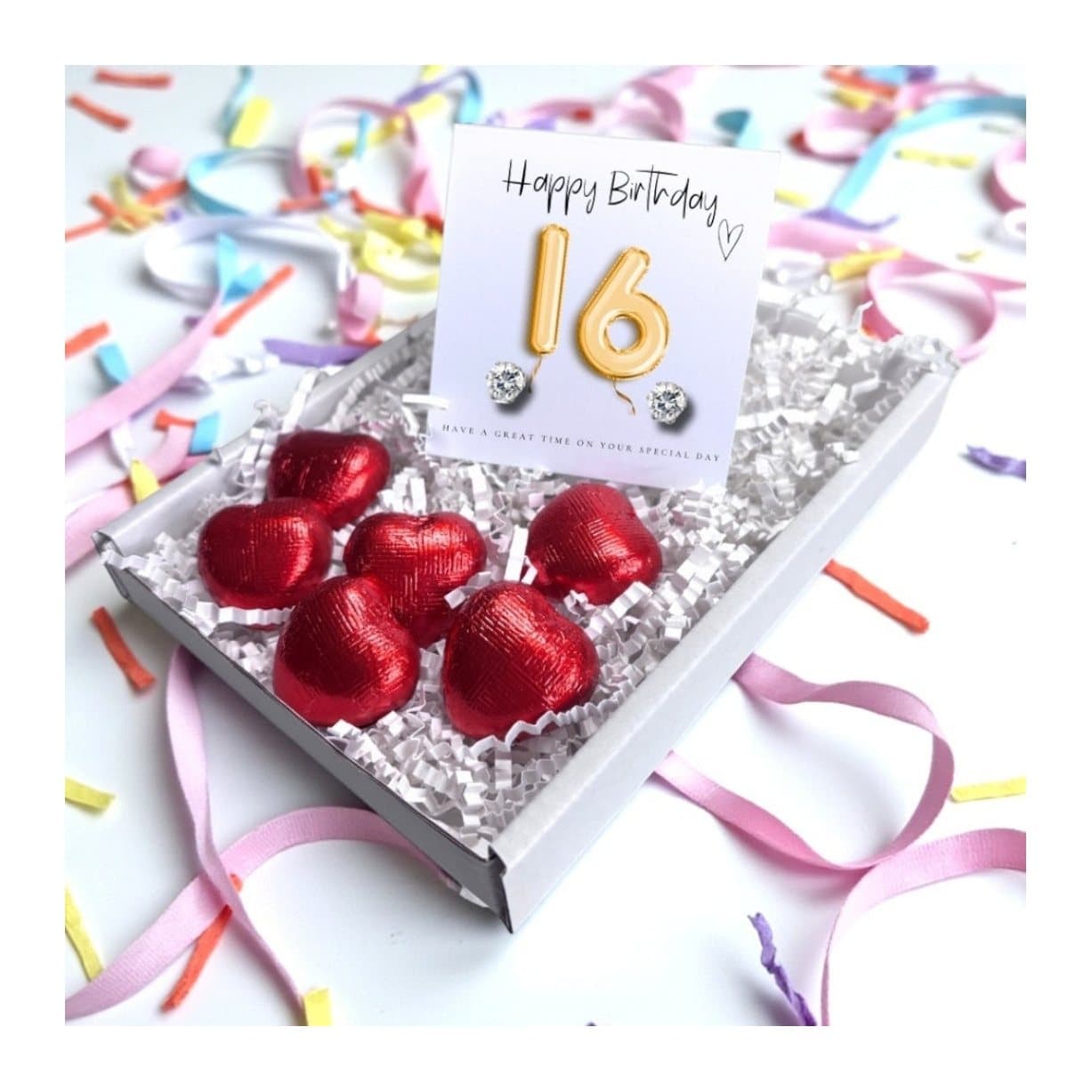 Cubic zirconia stud earrings and red foiled chocolate hearts with a gold balloons card