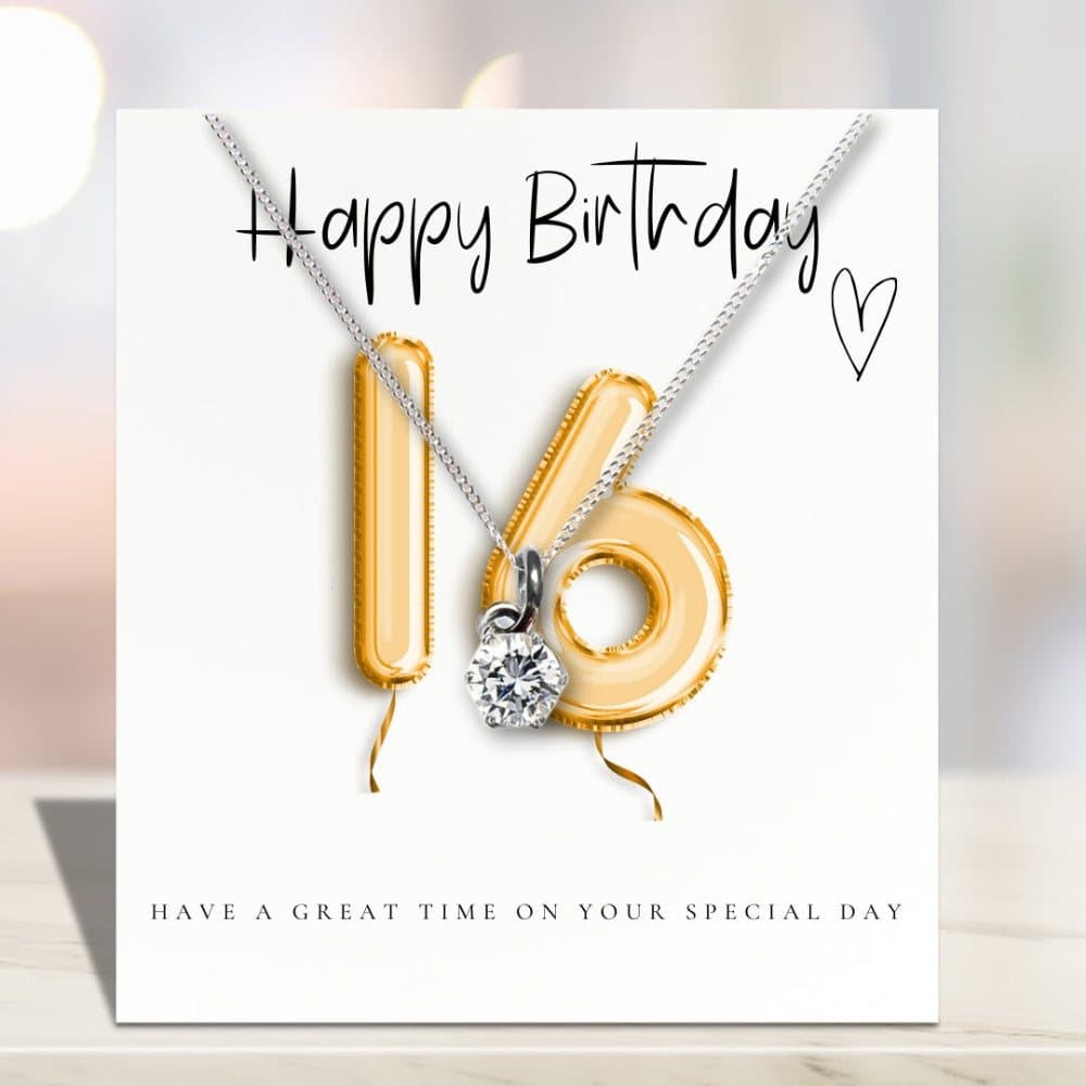 Silver necklace with a cubic zirconia charm and a gold balloons message card