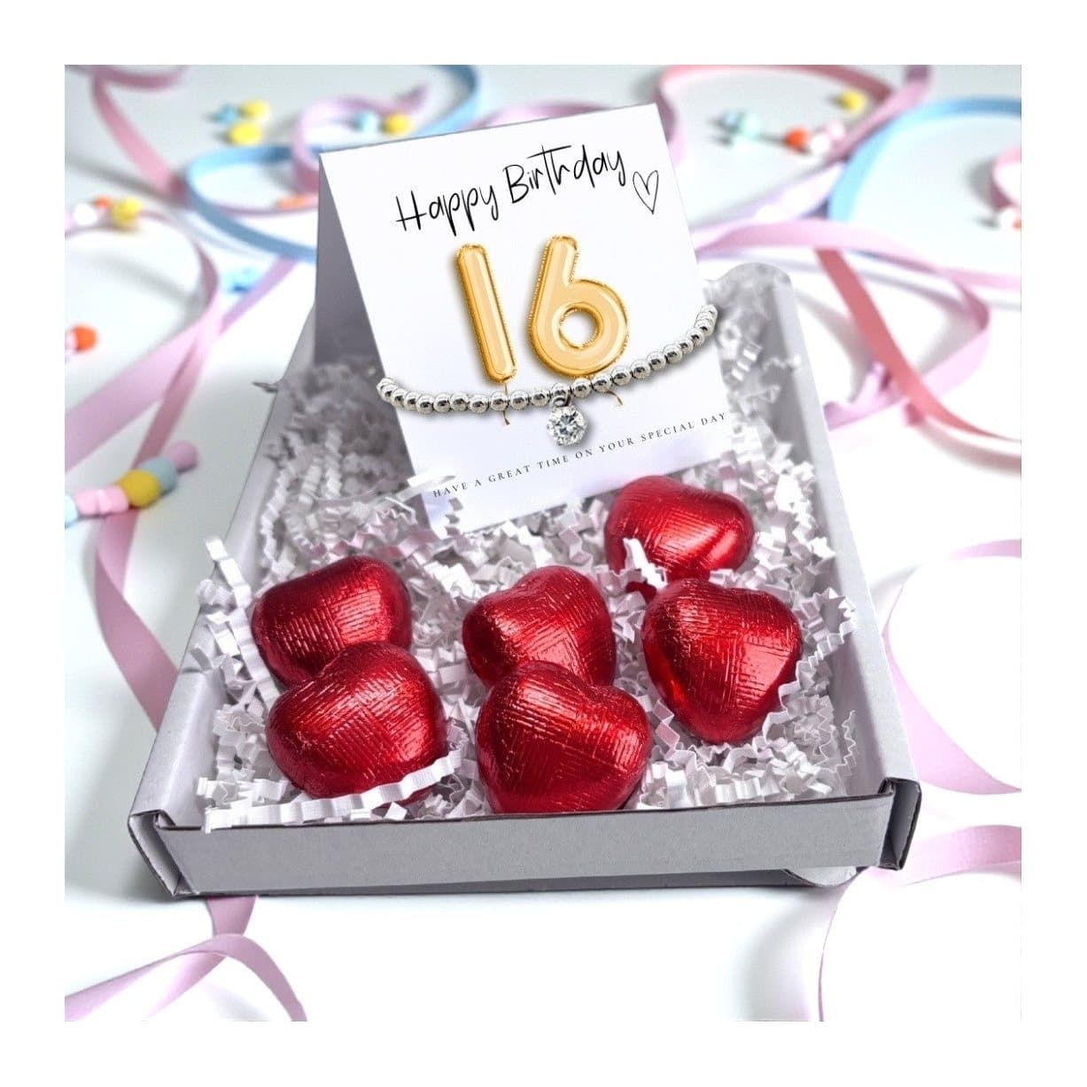 16th birthday gift box with bracelet, gold balloon card and chocolate hearts
