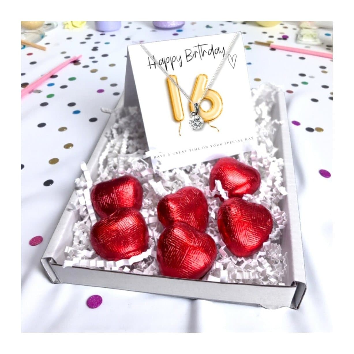 16th birthday gift box with a cubic zirconia necklace and red foiled chocolate hearts