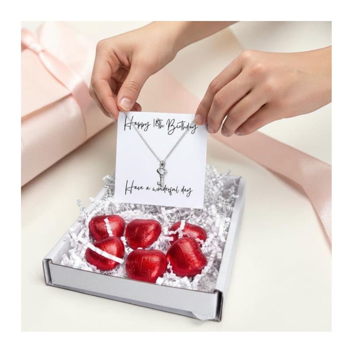 18th birthday gift box with a sterling silver key necklace and red chocolate hearts