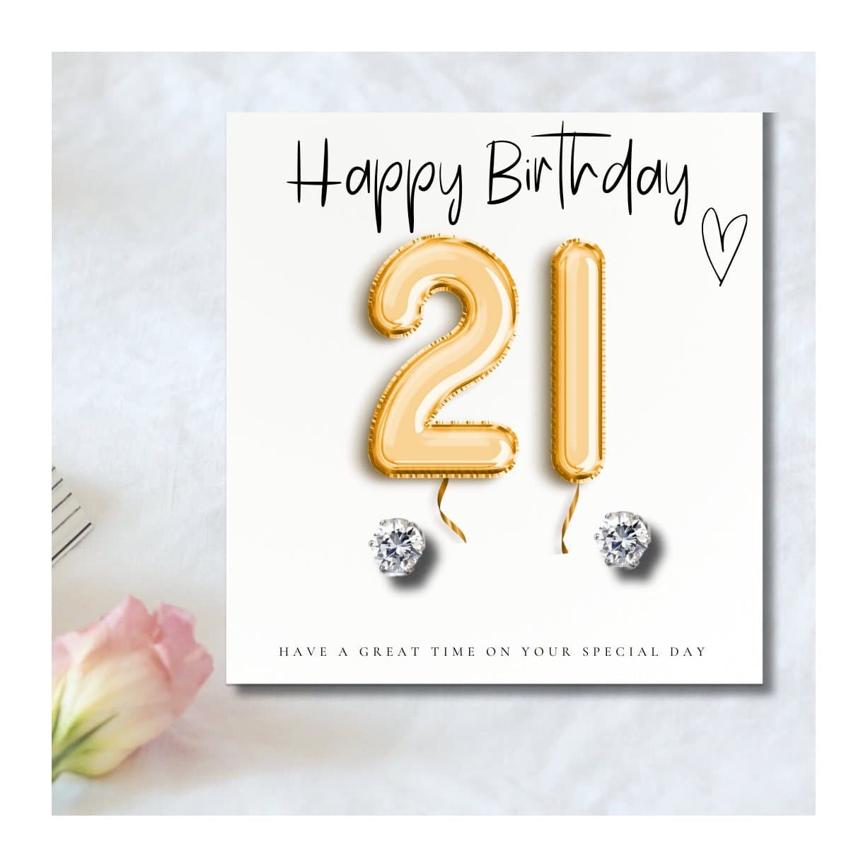 Silver cubic zirconia stud earrings with a gold balloons message card