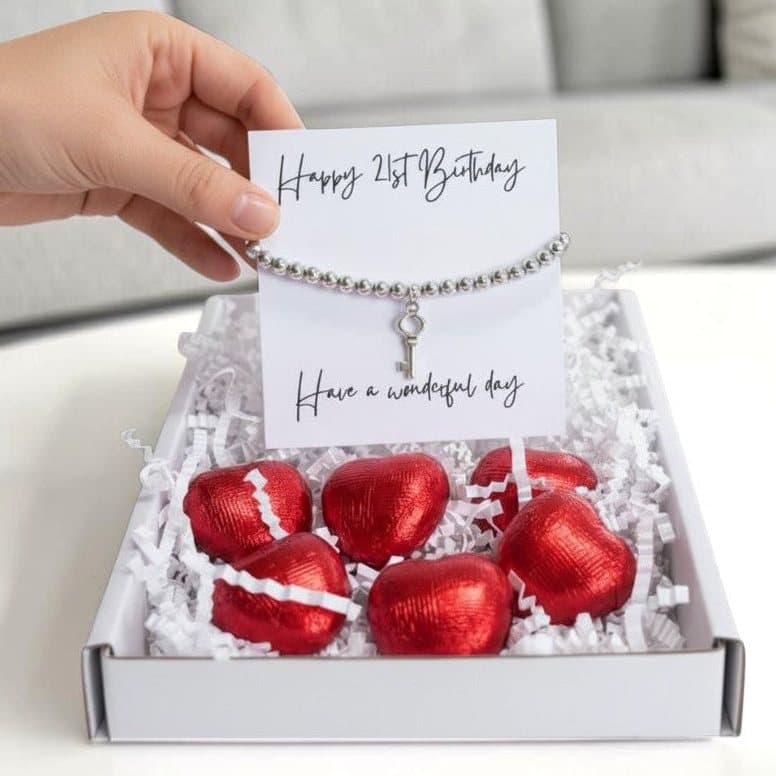 21st birthday gift box with a silver beaded key bracelet and red foiled chocolate hearts