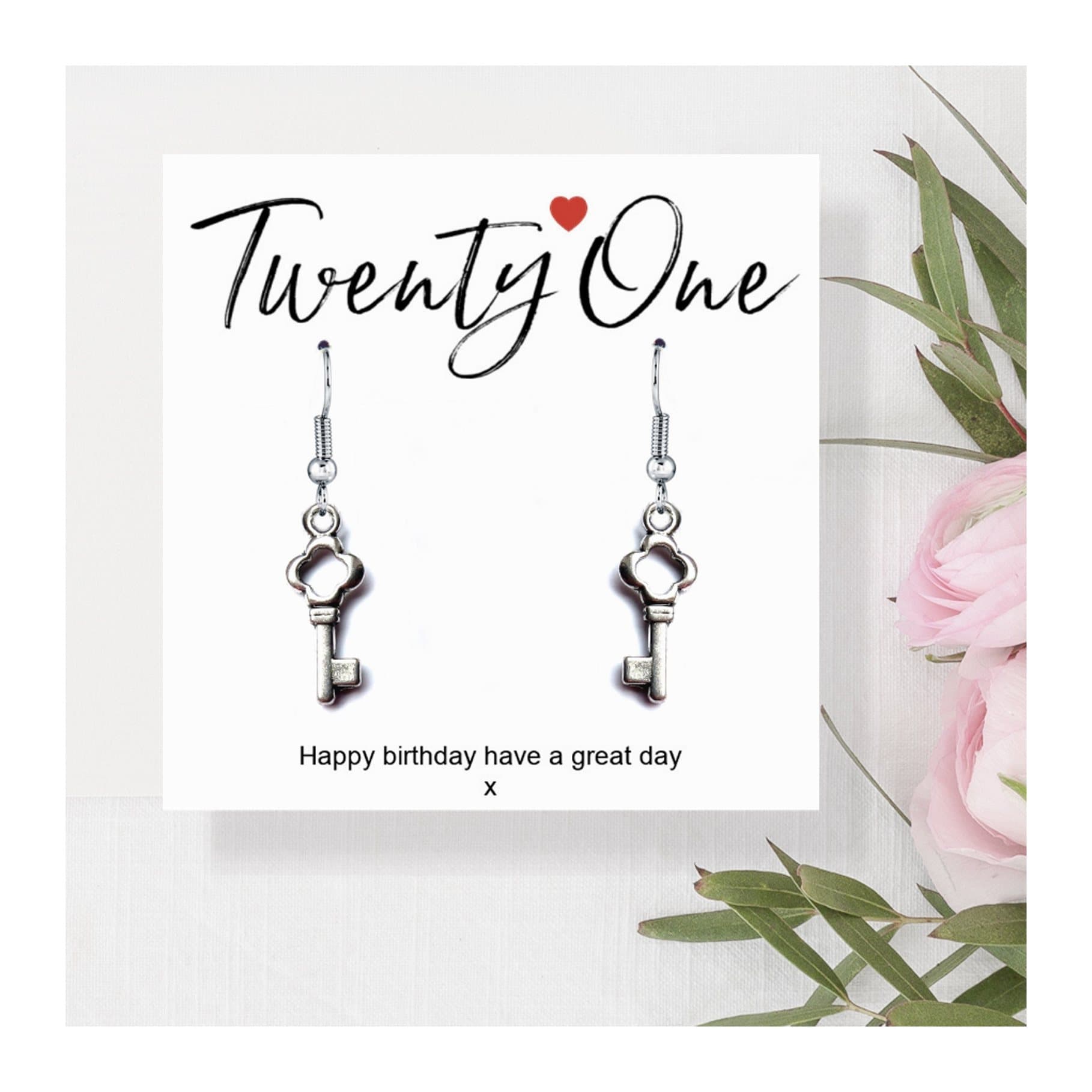 Silver drop earrings with a key charm and a 21st birthday card