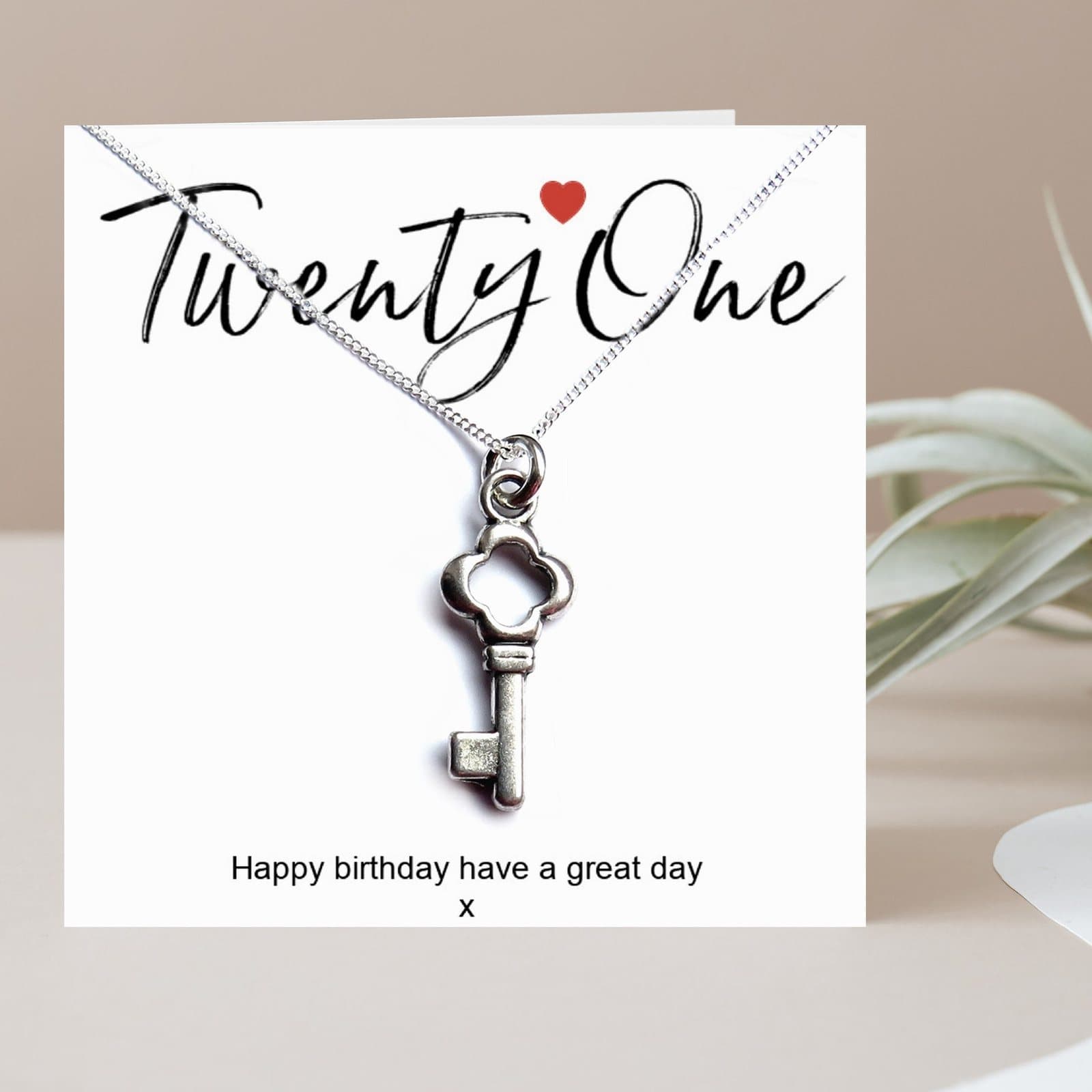 21st birthday necklace with a silver key charm and a birthday card