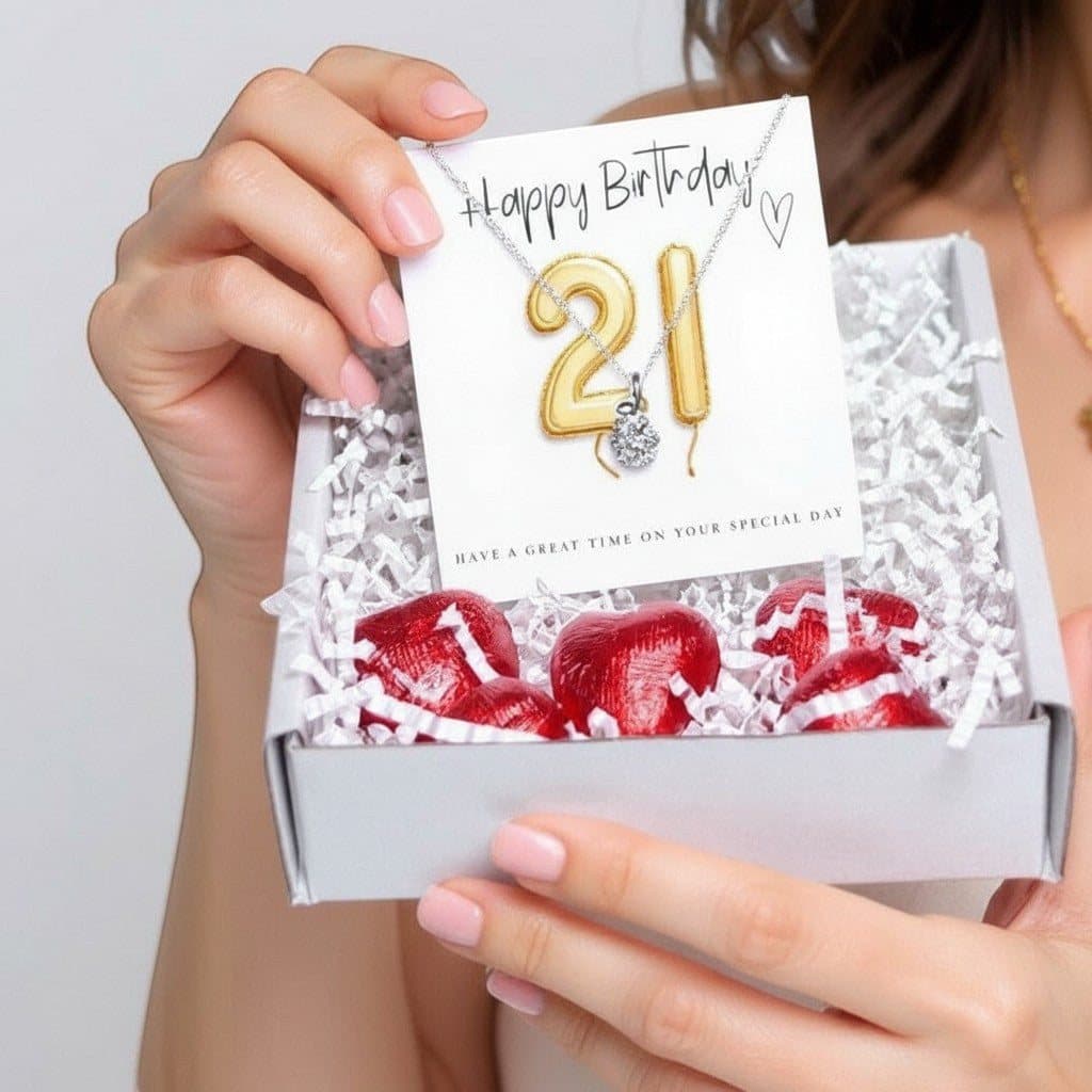 21st birthday gift box with a heart necklace, gold balloons and chocolate