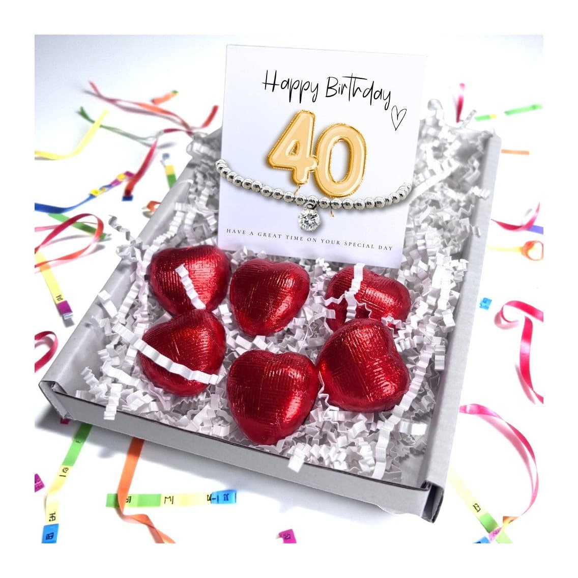 A 40th birthday gift box with a beaded bracelet, chocolate hearts and a gold balloon card