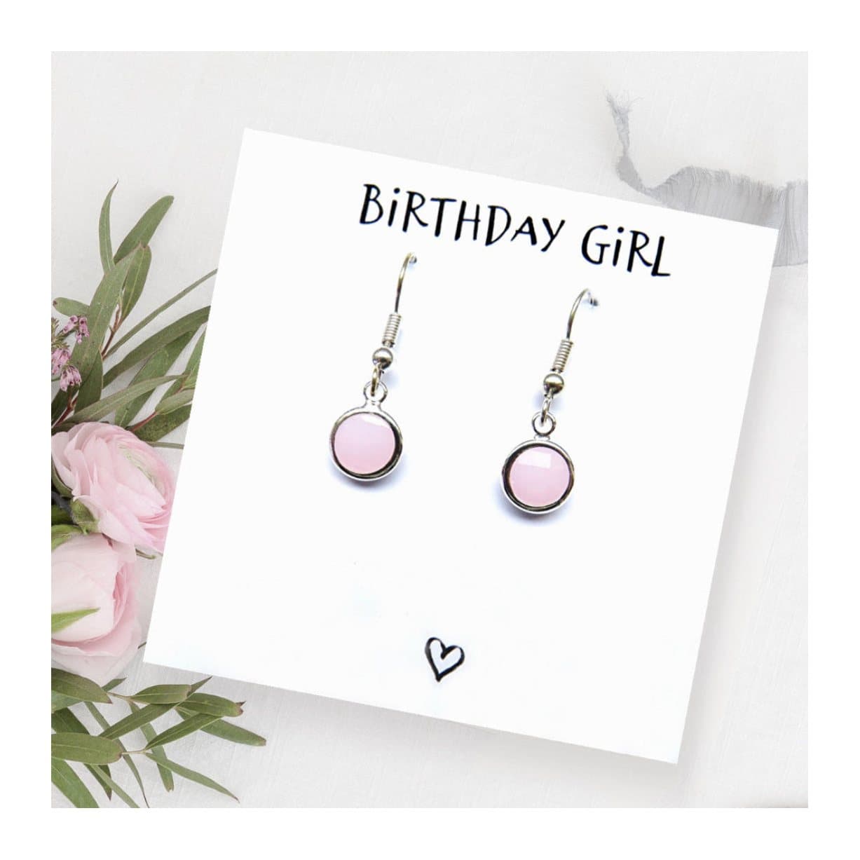 Birthstone drop earrings with a coloured glass charm, shown with a birthday girl card