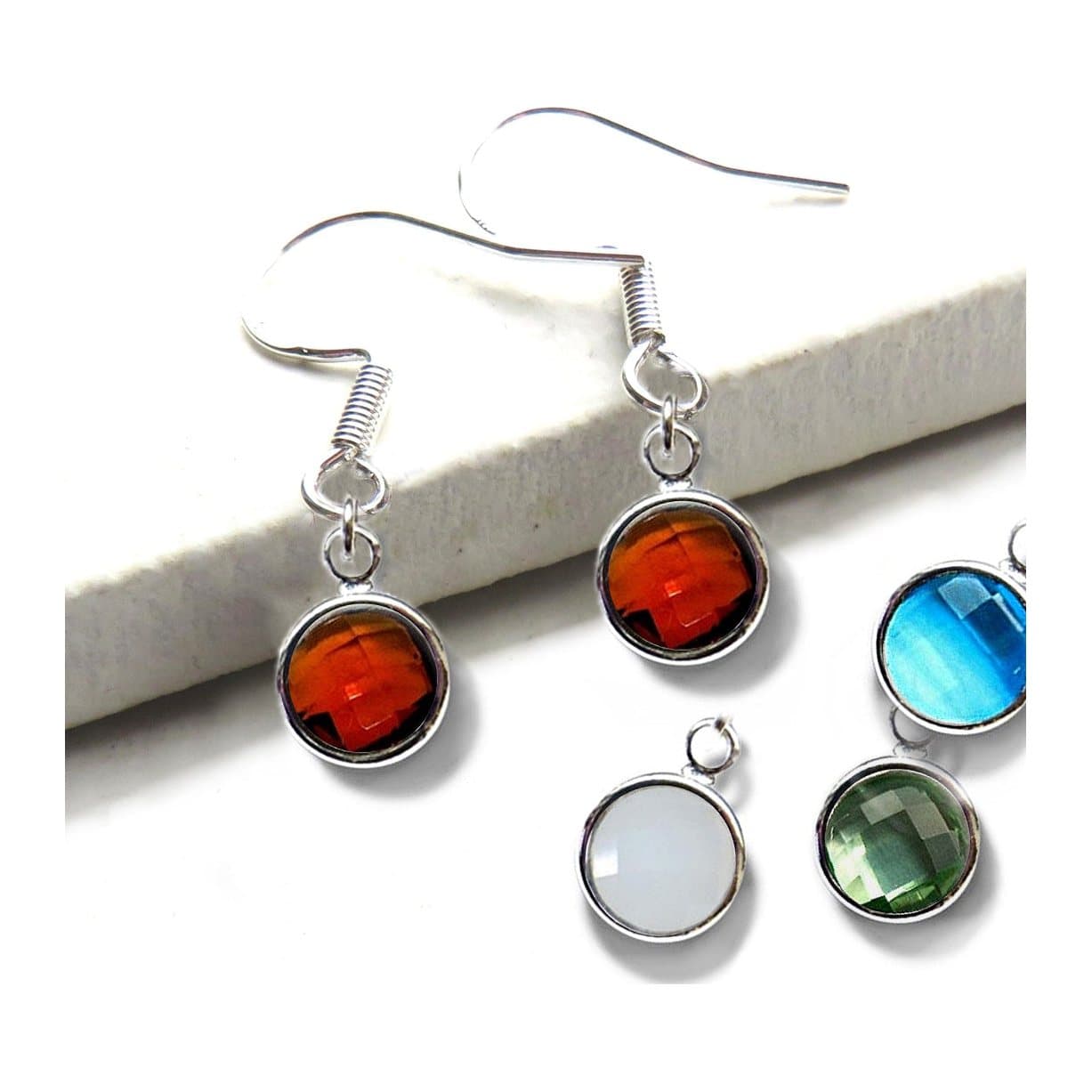Silver drop earrings with a faceted coloured glass birthstone
