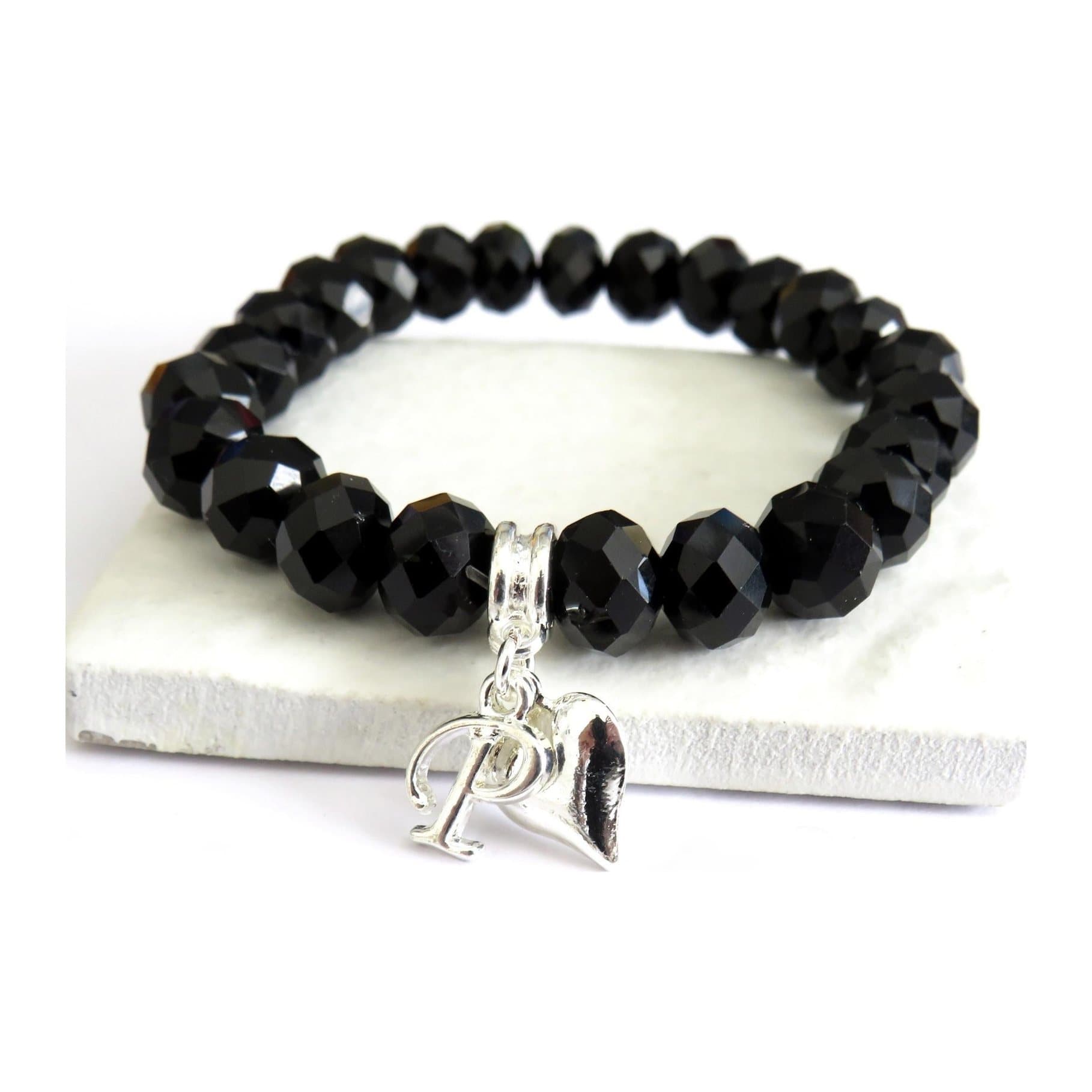 Black crystal beaded bracelet with an initial charm and a silver plated heart charm