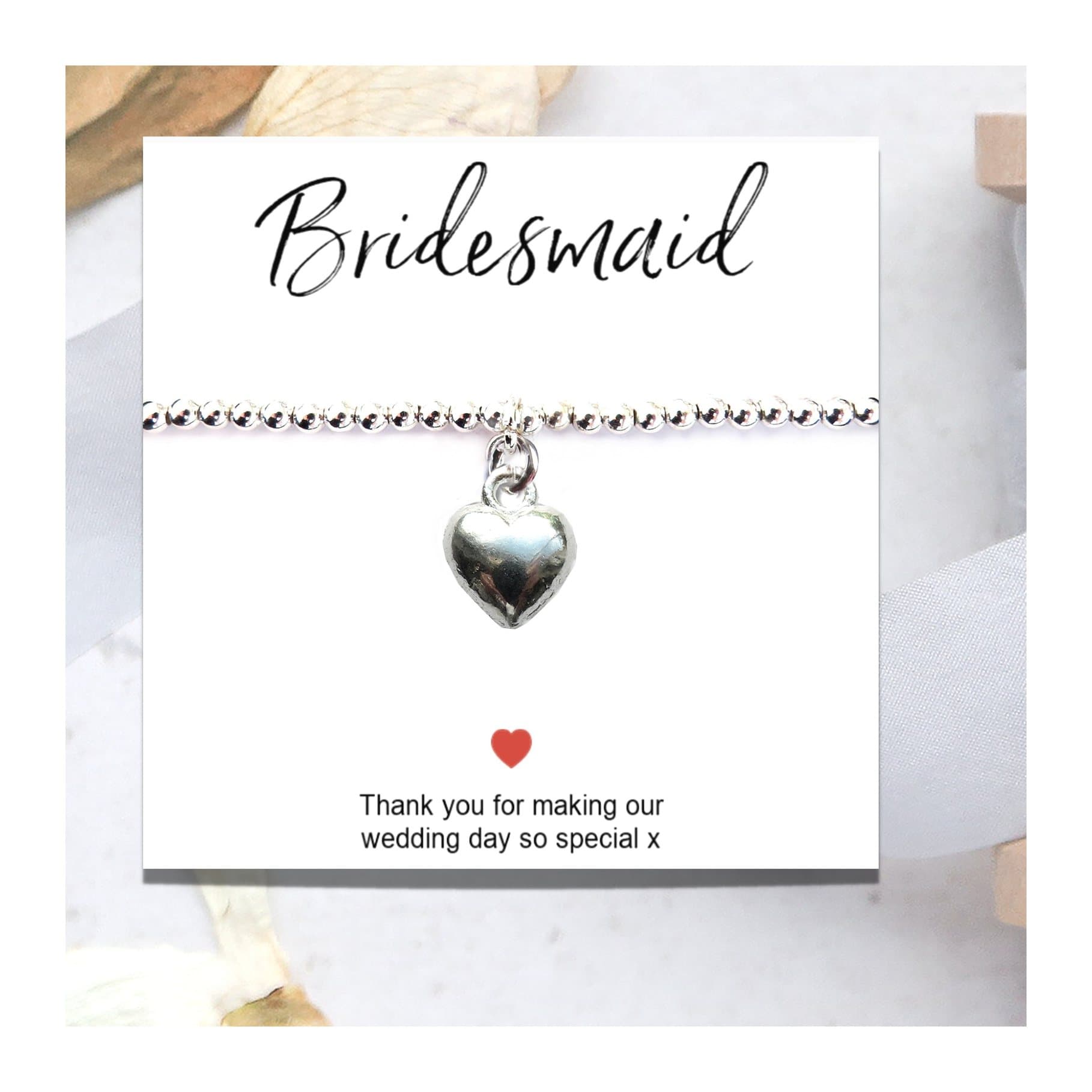 Silver plated heart bracelet on a thank you gift card for bridesmaids