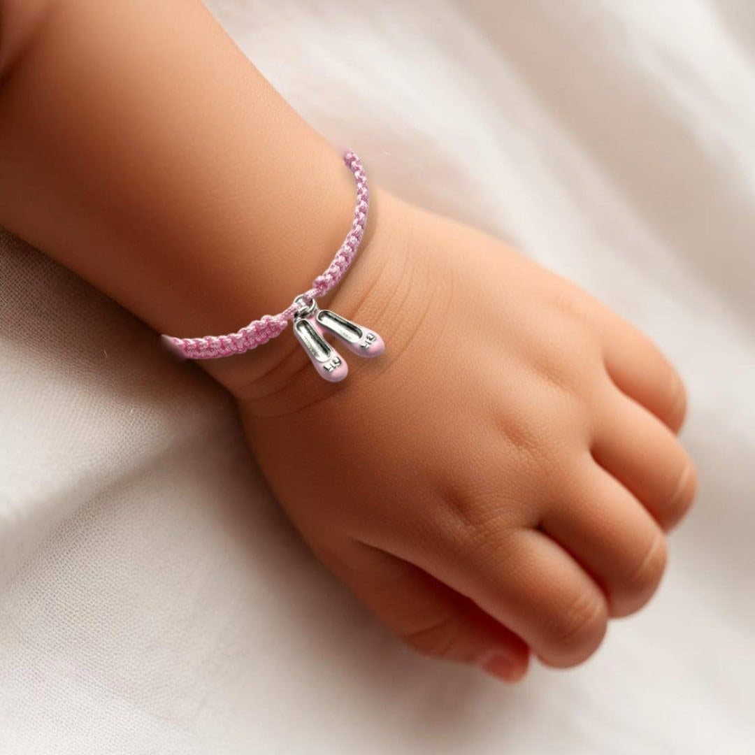 Pink ballet shoe charm on an adjustable braided friendship bracelet