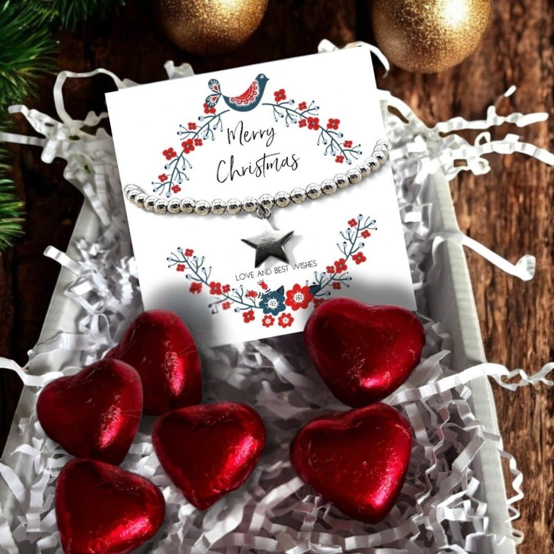Christmas gift box with a silver beaded star bracelet and red foiled milk chocolate hearts