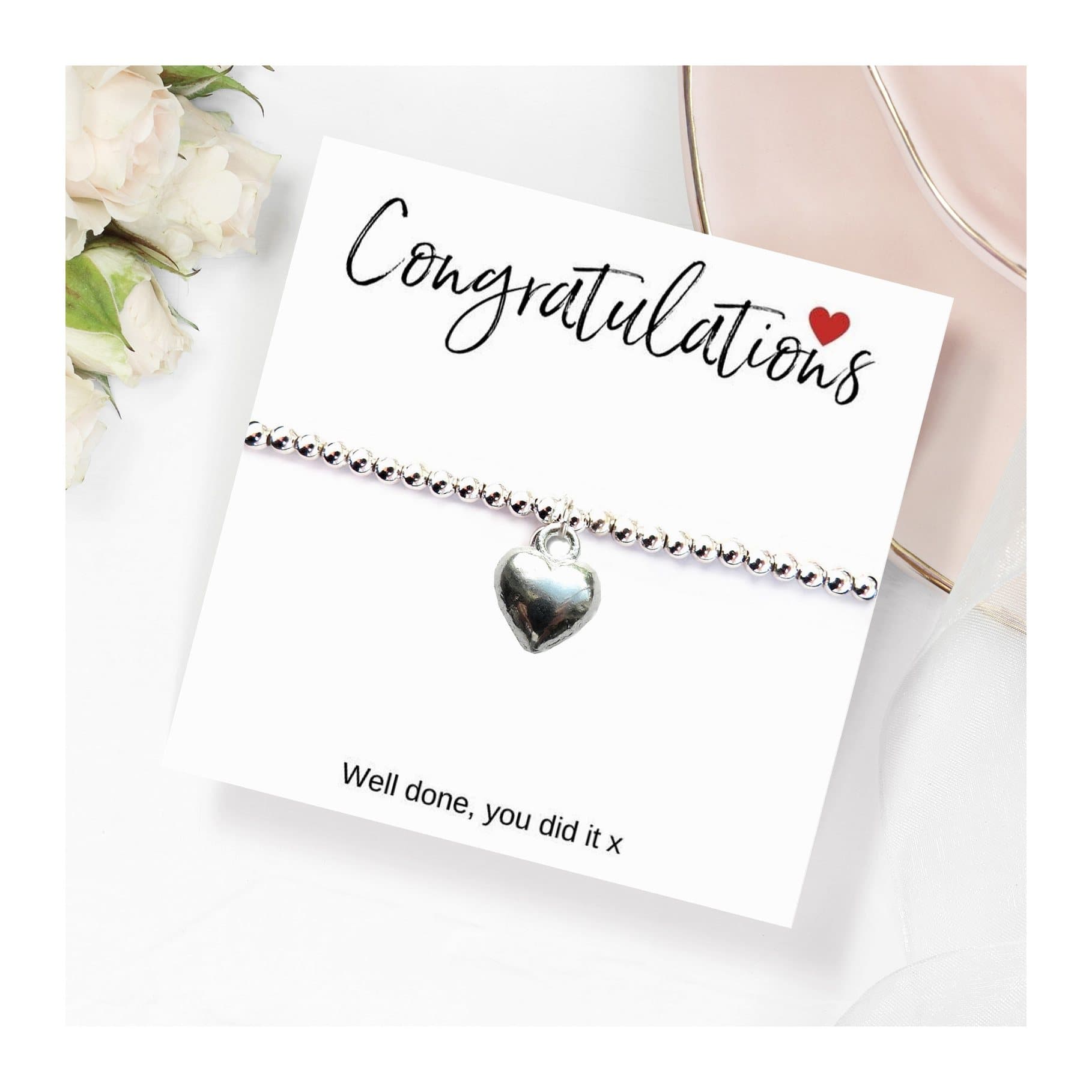 Silver heart charm on a stretch beaded bracelet, with a congratulations message card