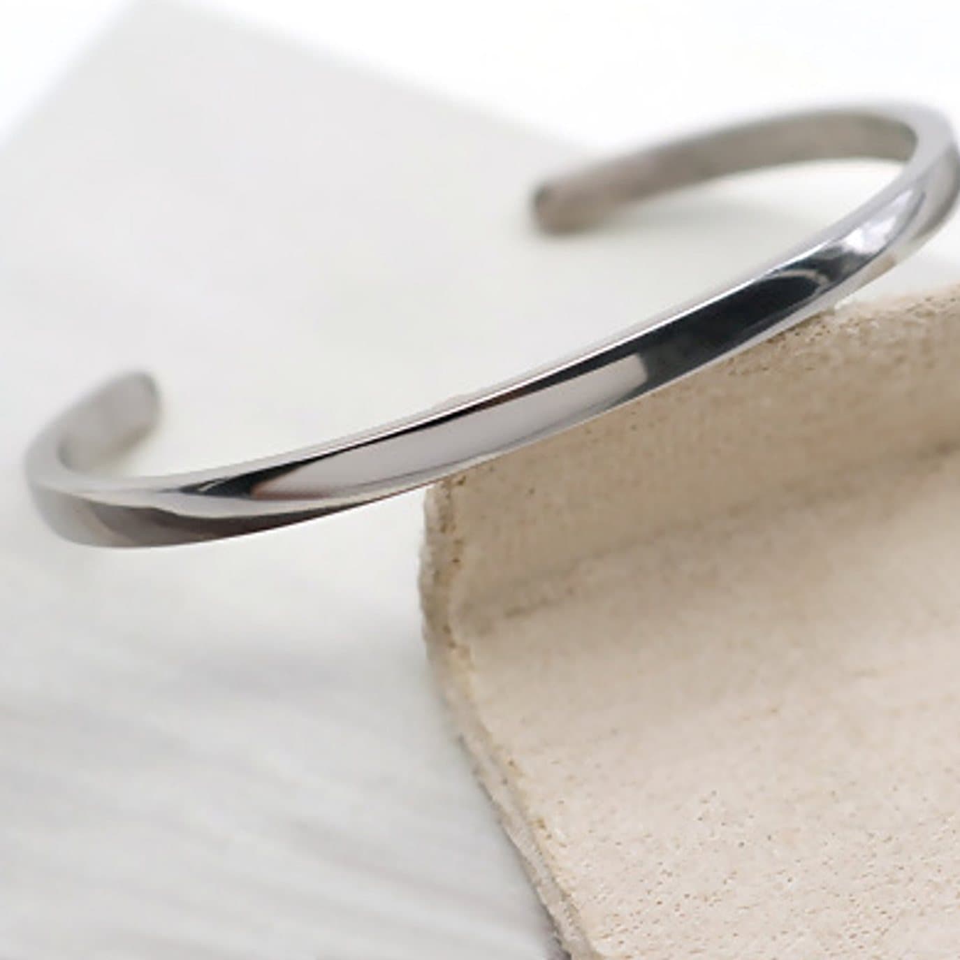 Silver cuff bangle with a minimalist design.