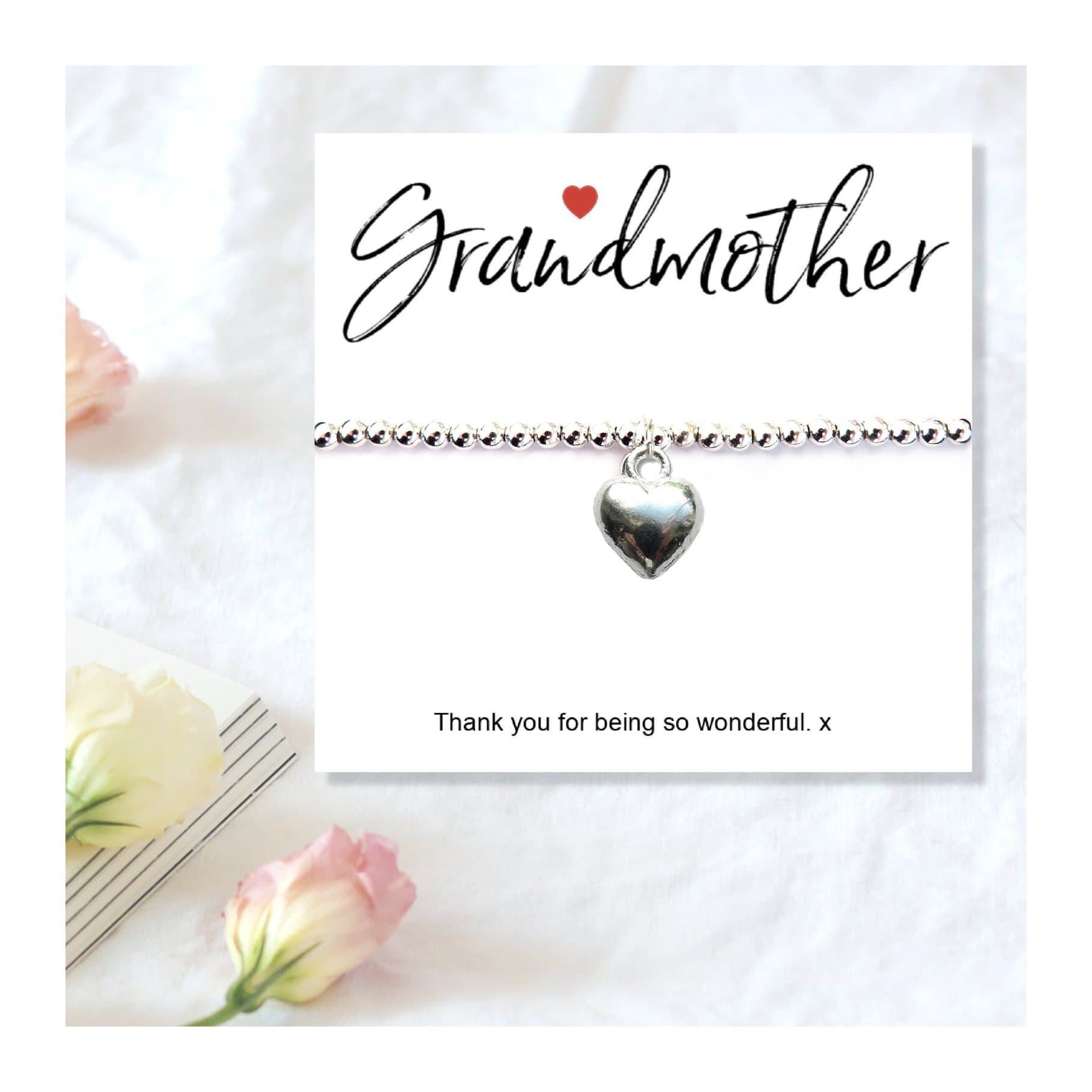 Silver heart charm bracelet presented on a message gift card