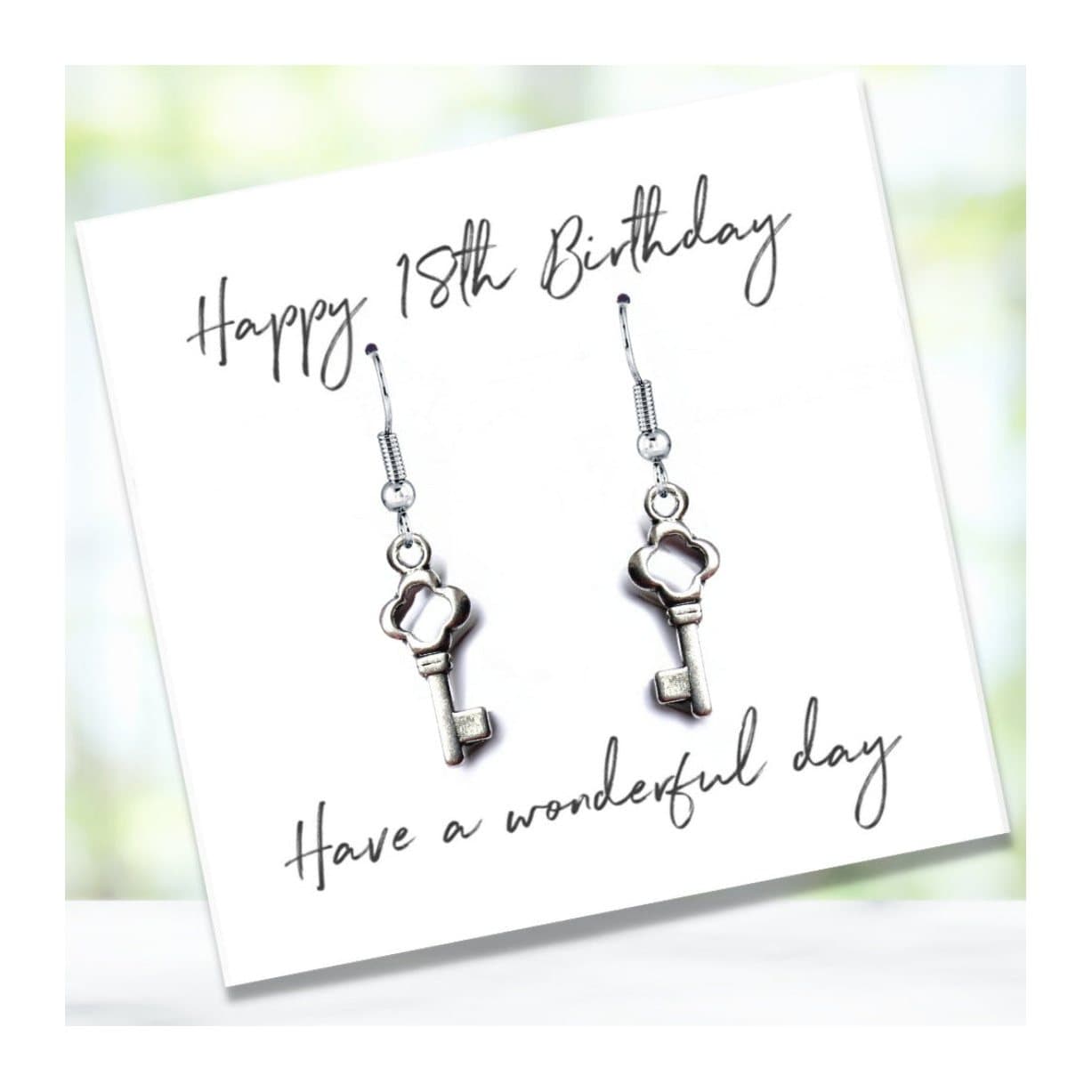 Drop earrings with a key charm, shown with a Happy 18th Birthday message card