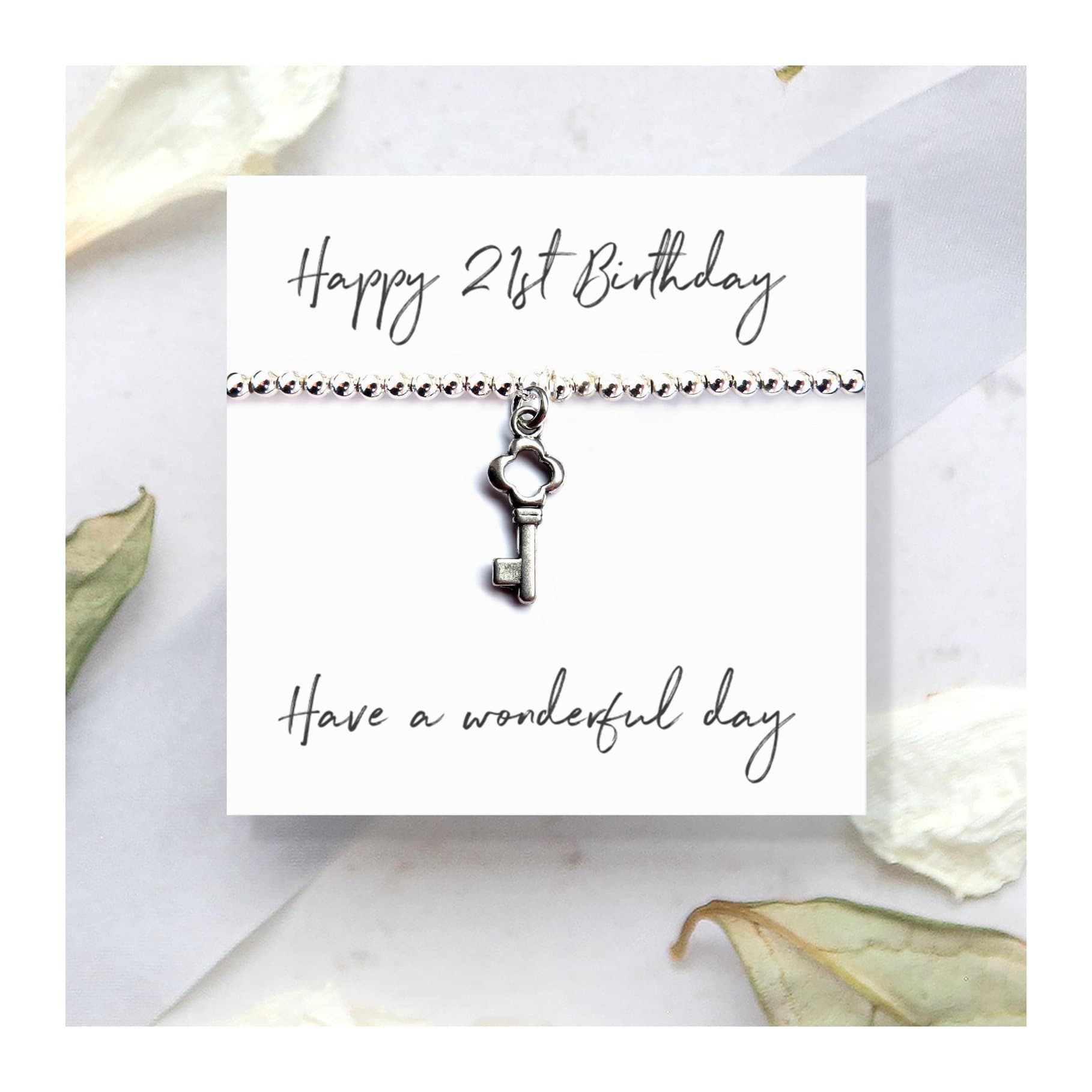 21st birthday stretch bracelet with a key charm and a Happy 21st Birthday card
