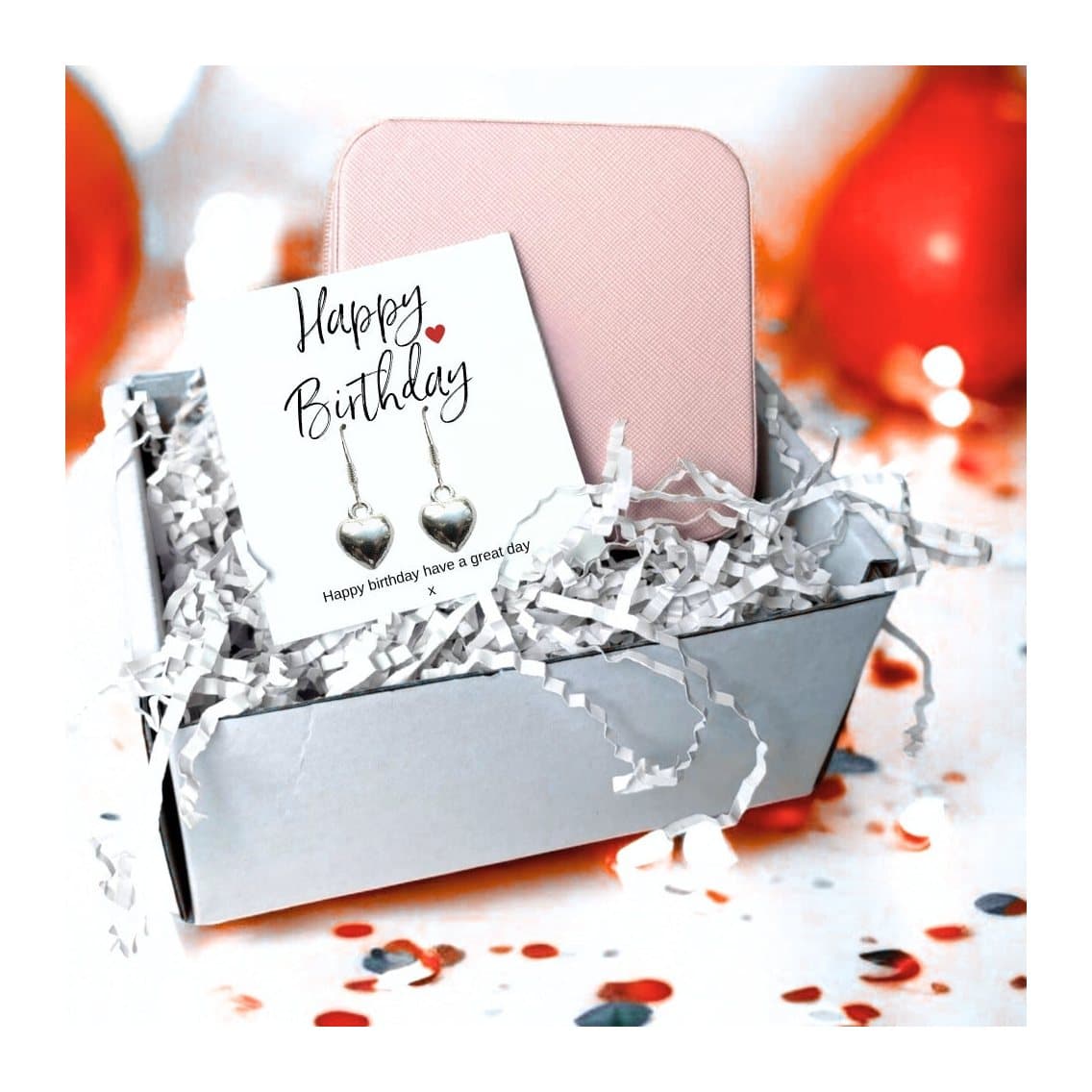 Silver heart earrings on a message card, with a pink jewellery box