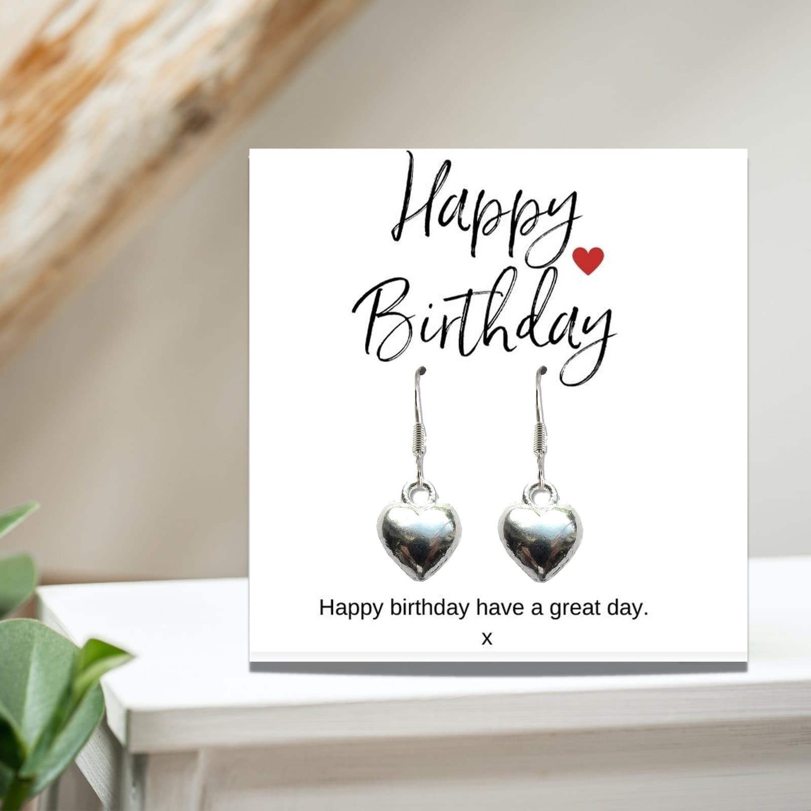 Silver heart earrings presented on a Happy Birthday message card