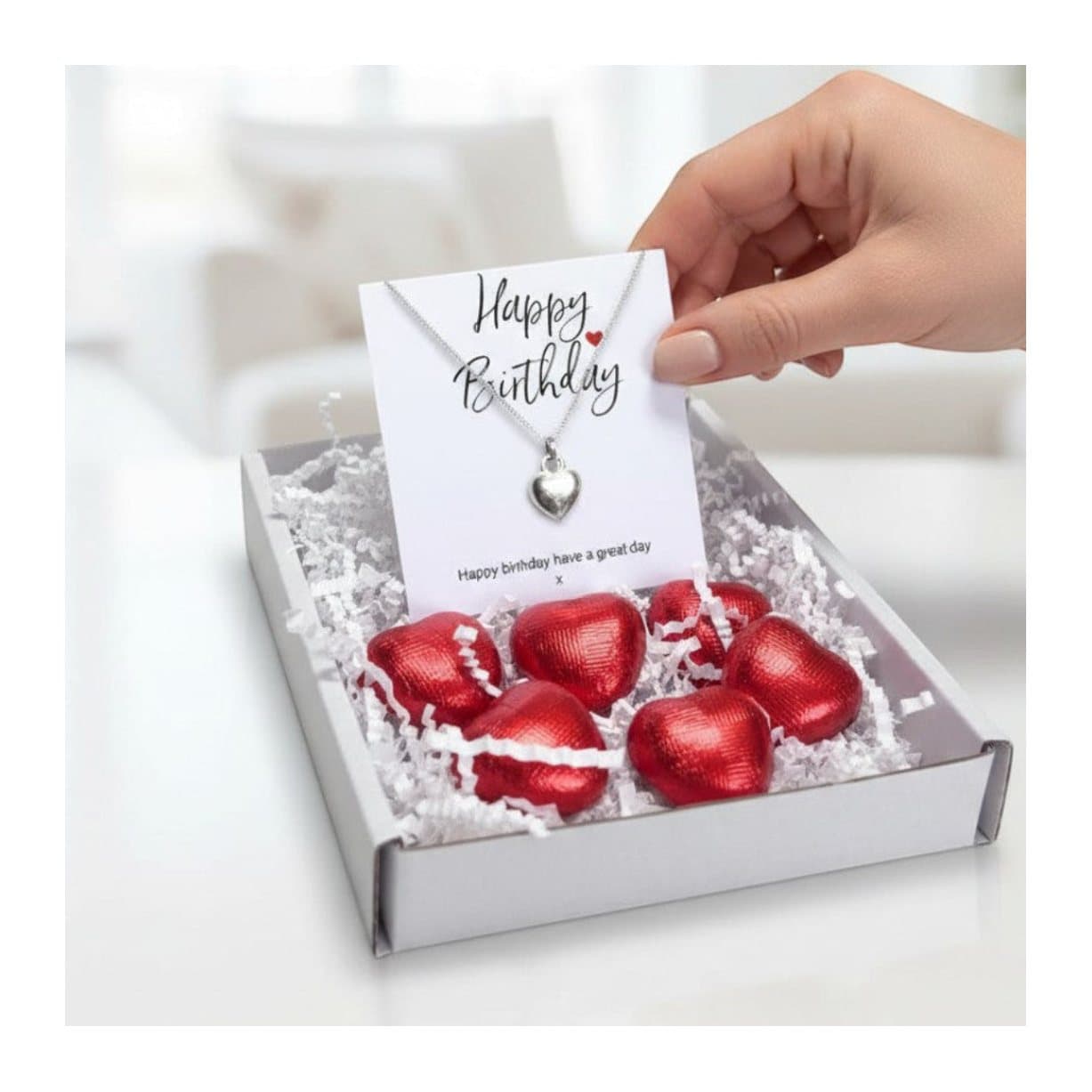 Birthday gift box with a silver heart necklace and red foiled milk chocolate hearts