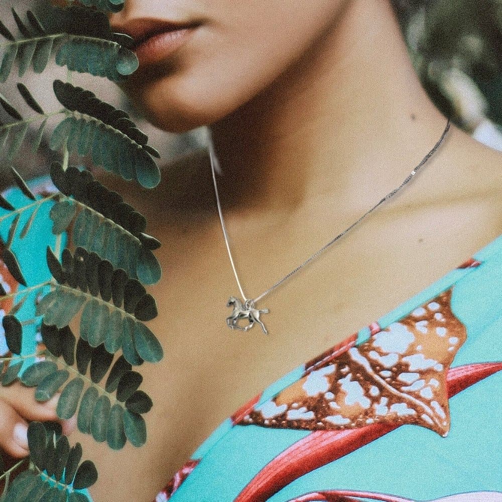 Silver horse charm necklace with a horseshoe charm on a chain