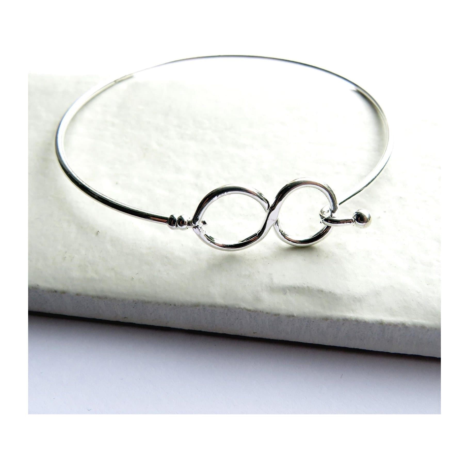 Silver-plated cuff bangle with an infinity symbol design