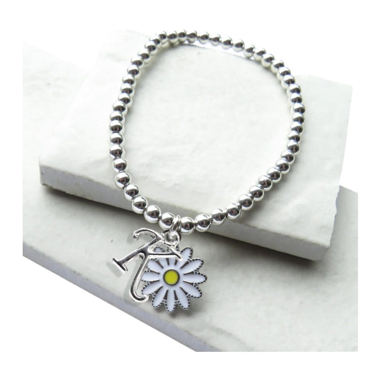 Silver beaded stretch bracelet with a silver initial and a white daisy charm
