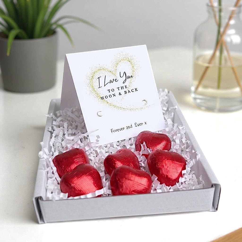Sterling silver stud earrings and red foiled milk chocolate hearts in a gift hamper