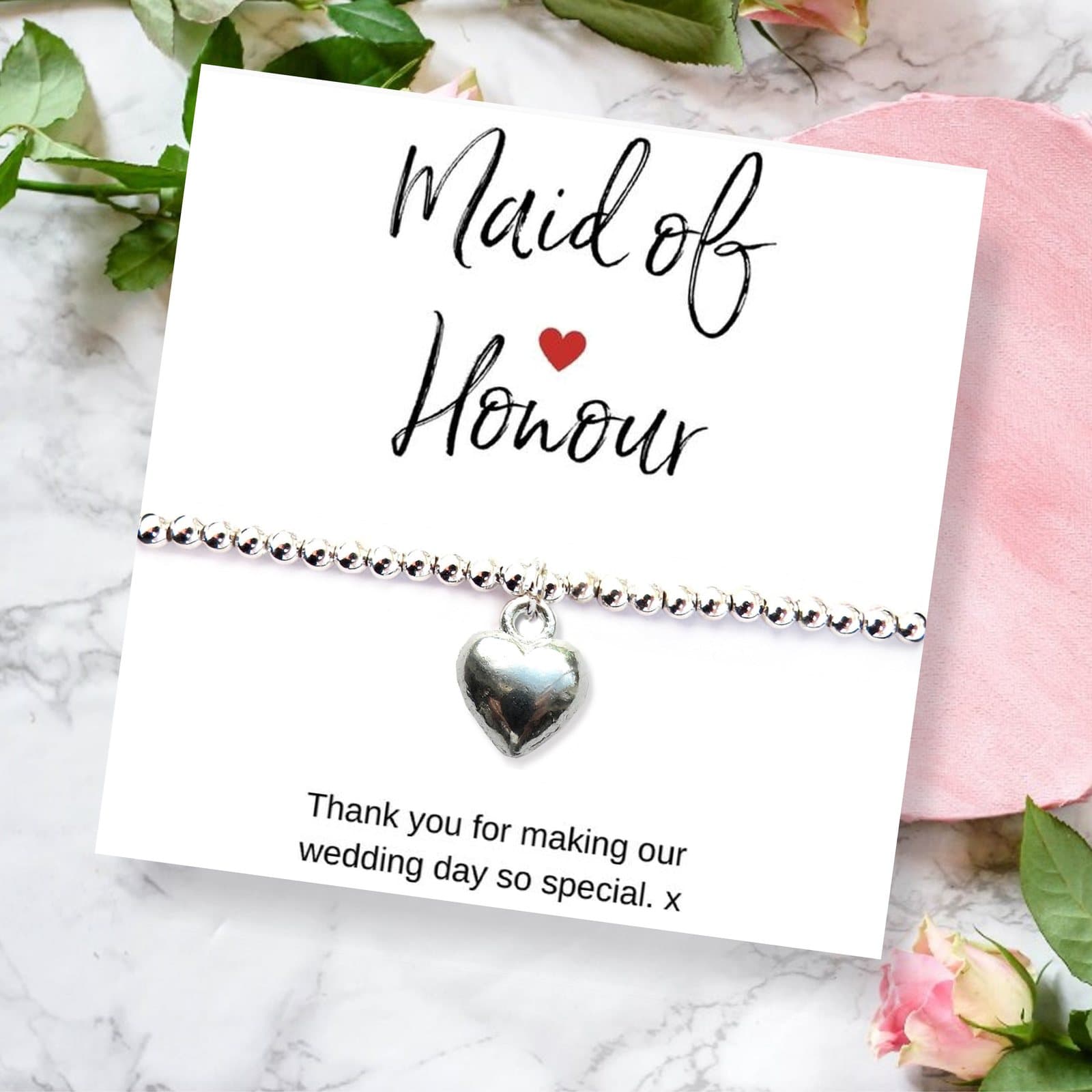 Silver heart charm bracelet with a thank you card for a maid of honour