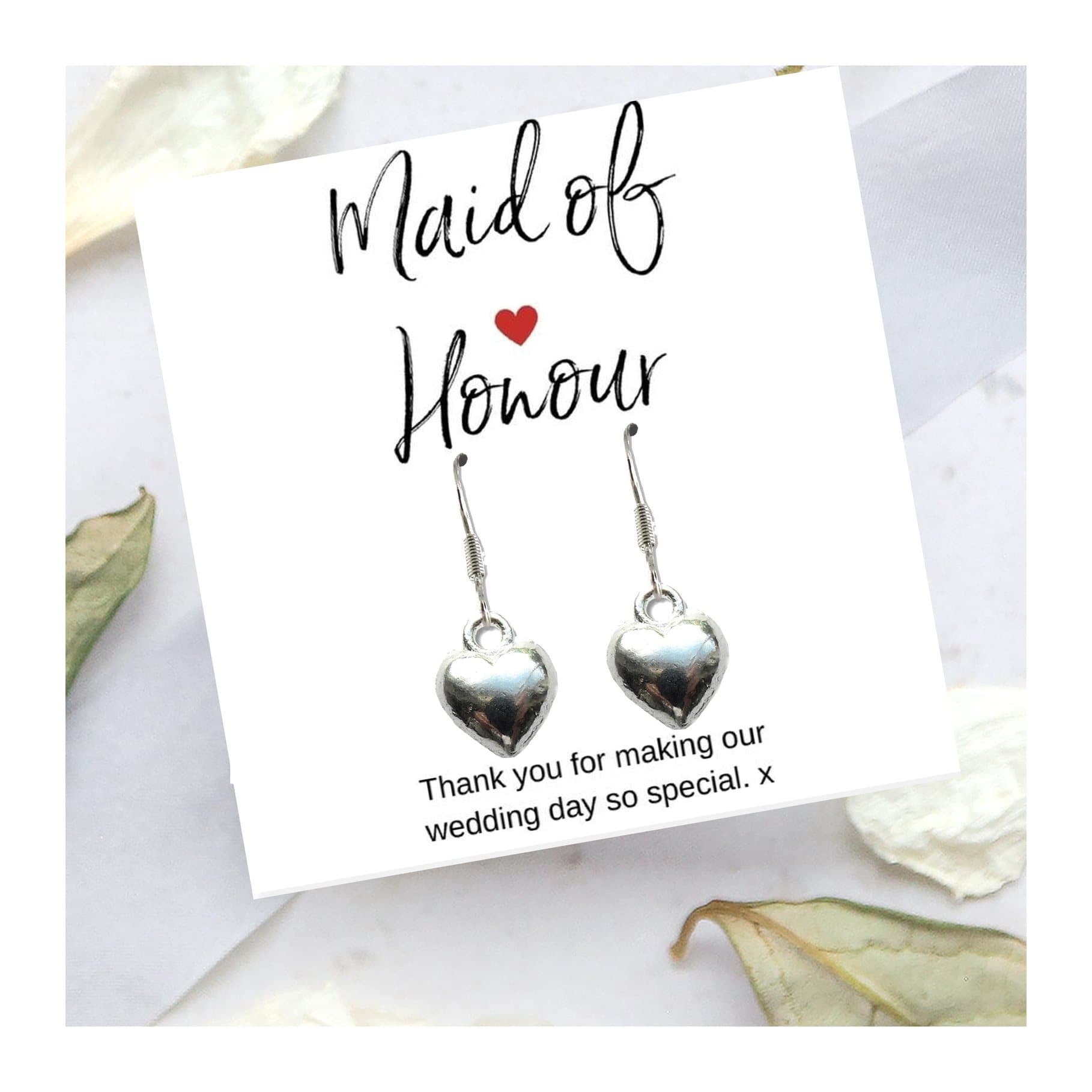 Silver plated puff heart earrings with a thank you message card