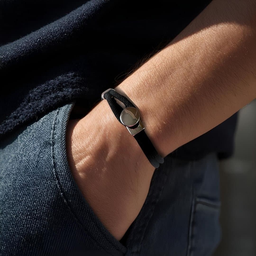 Men's black braided nylon bracelet with a silver button