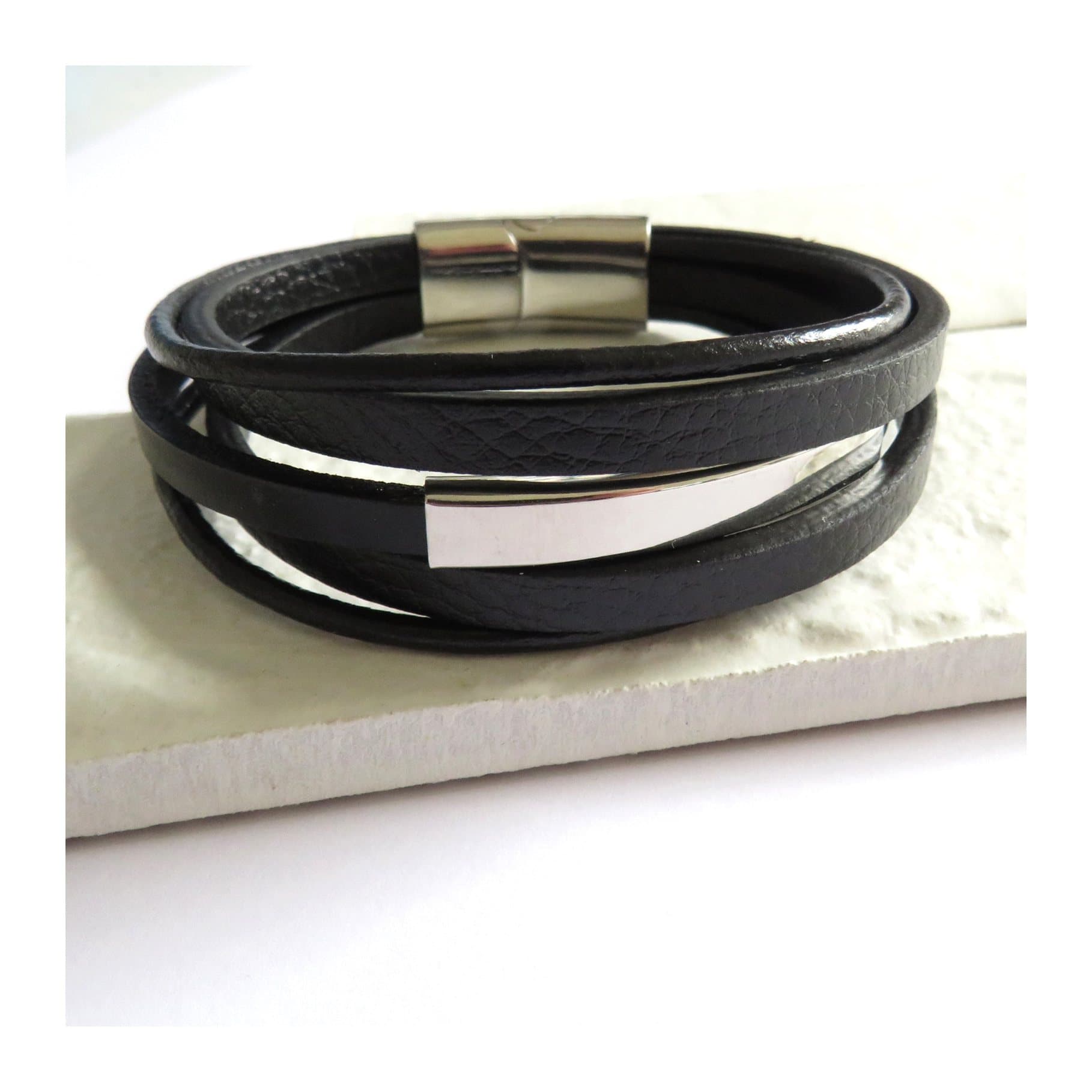 Black multi strand leather bracelet with a stainless steel rectangle bar feature