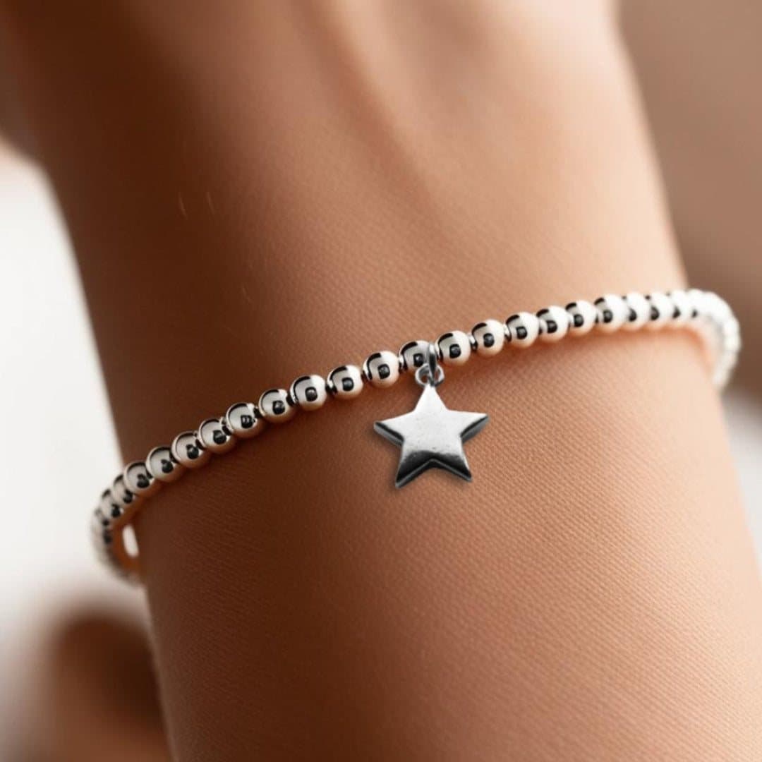 Christmas gift box with a silver beaded star bracelet and red foiled chocolate hearts