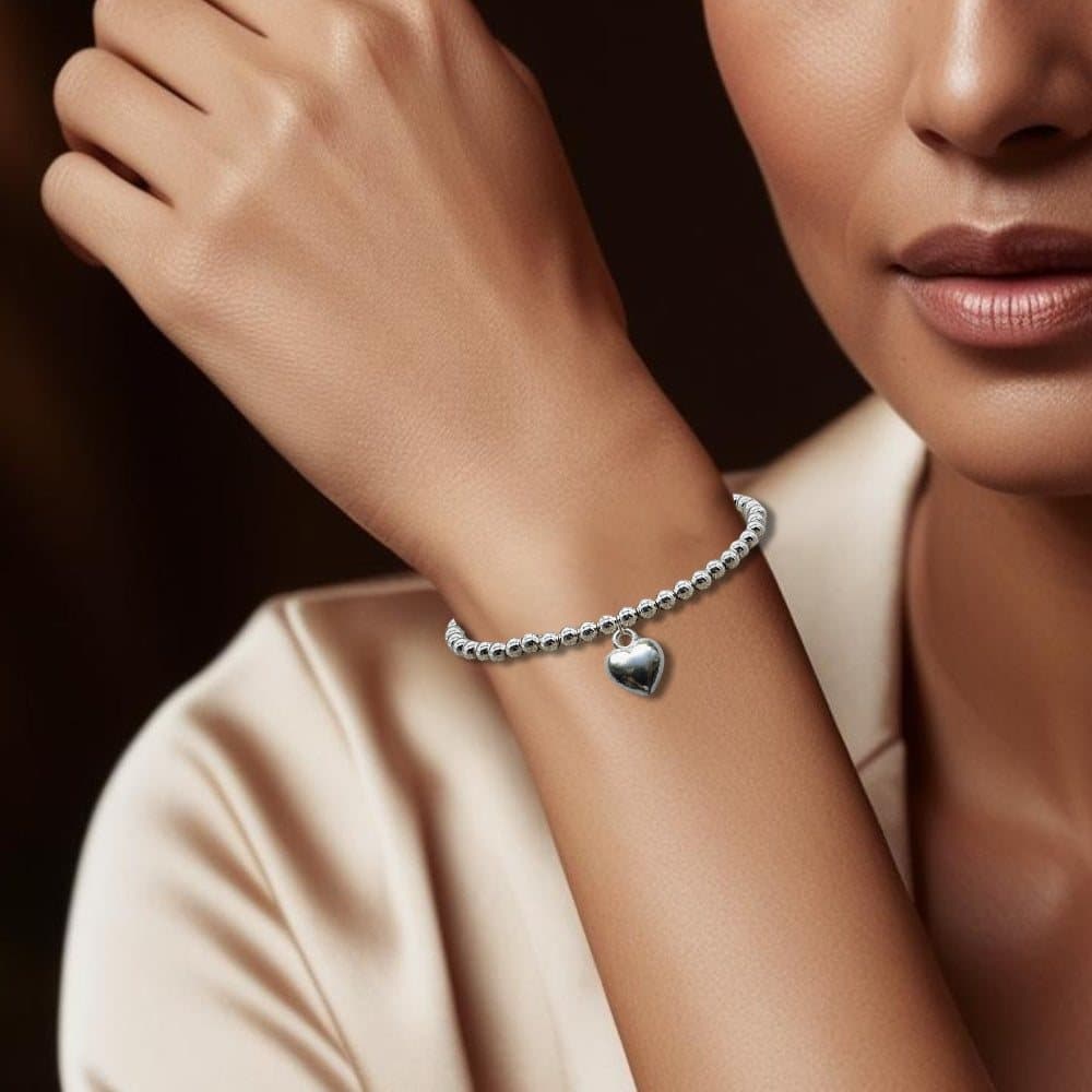 Merry Christmas gift box with a silver heart bracelet and chocolate hearts