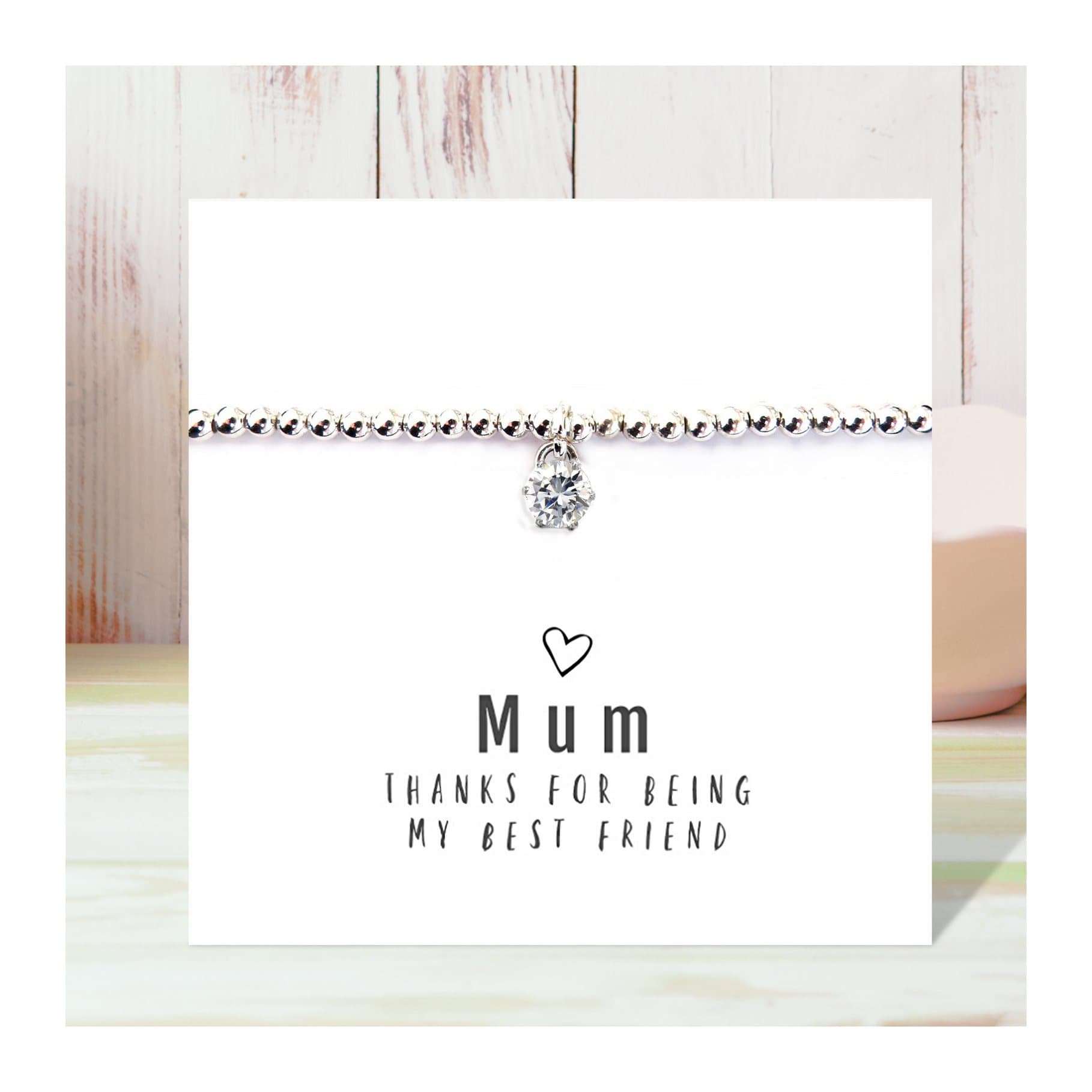 Stretch beaded bracelet with a cubic zirconia charm and message card