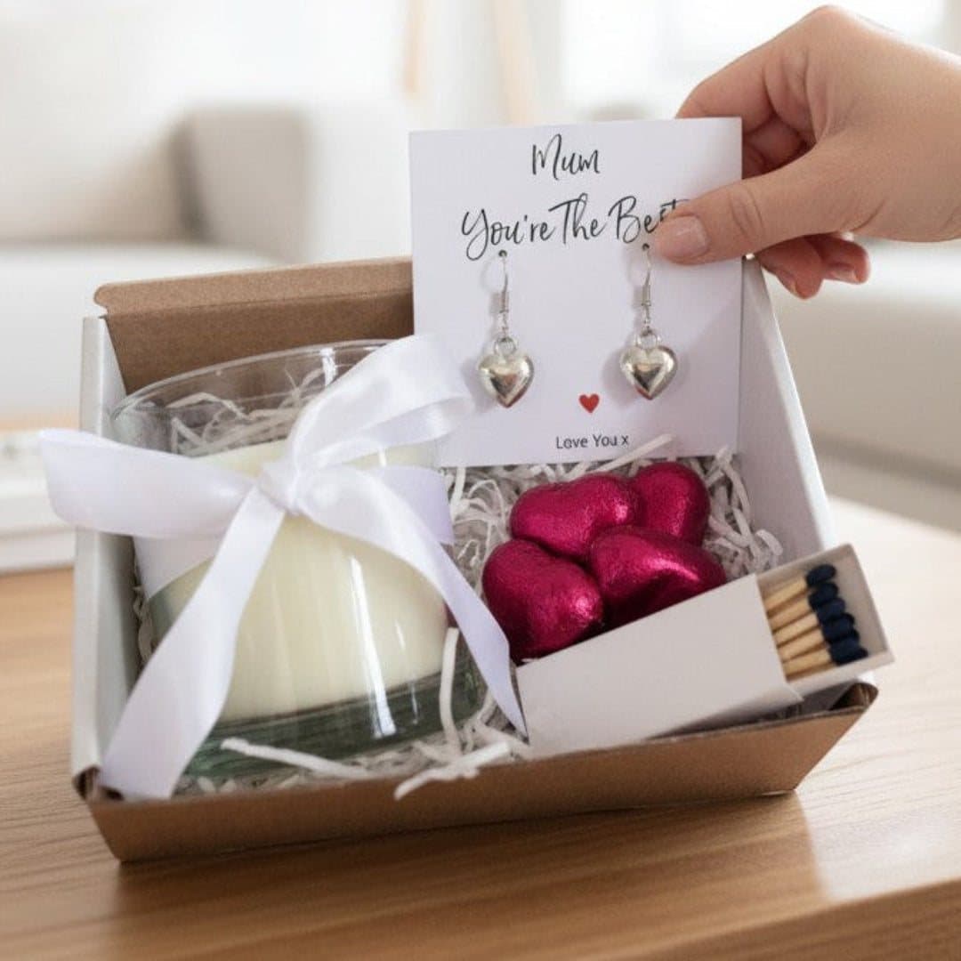 Puff heart drop earrings, a candle, red foiled milk chocolate hearts and a message card
