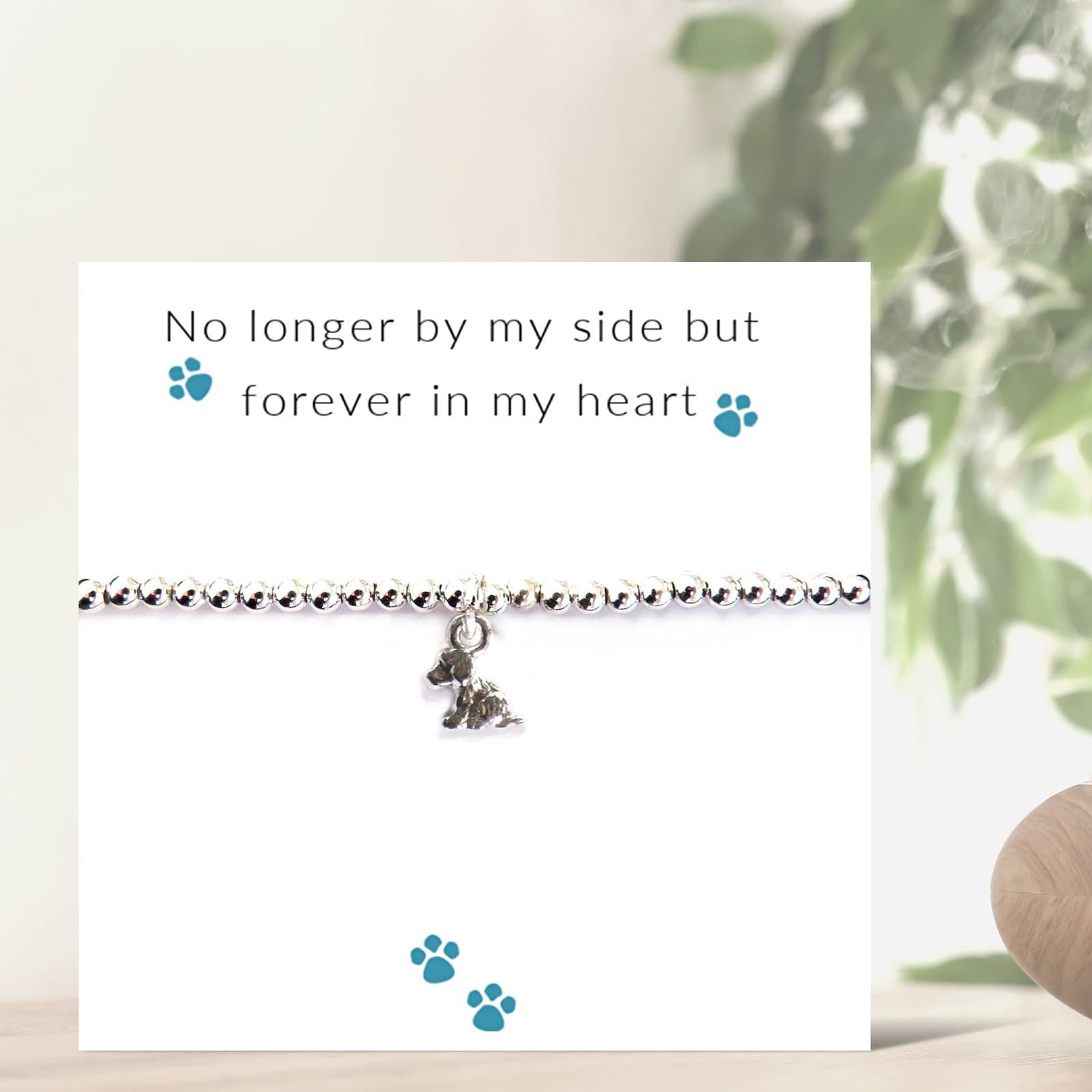 Silver beaded stretch bracelet with a puppy dog charm, presented on a message card.