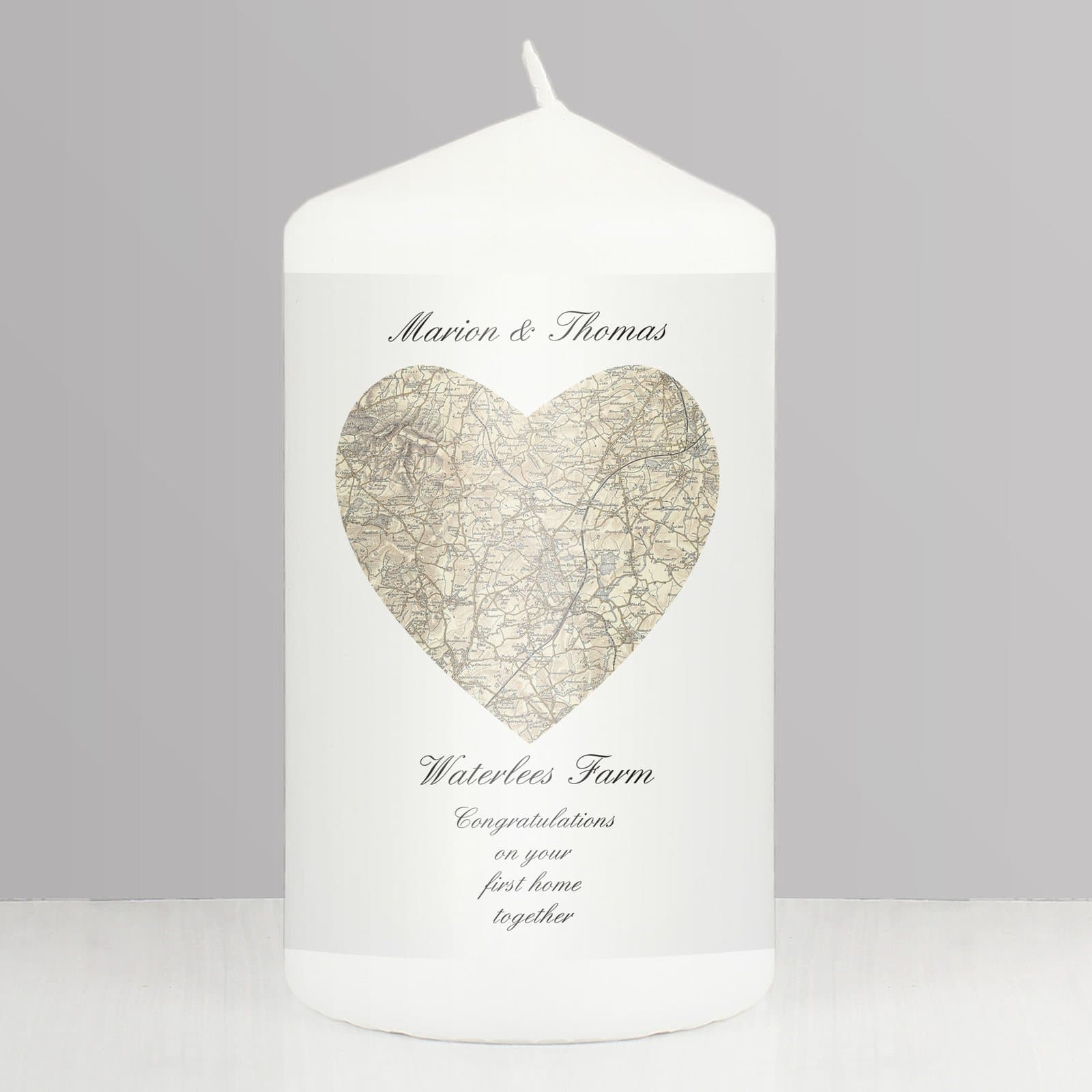 Pillar candle with a heart map design in an organza bag