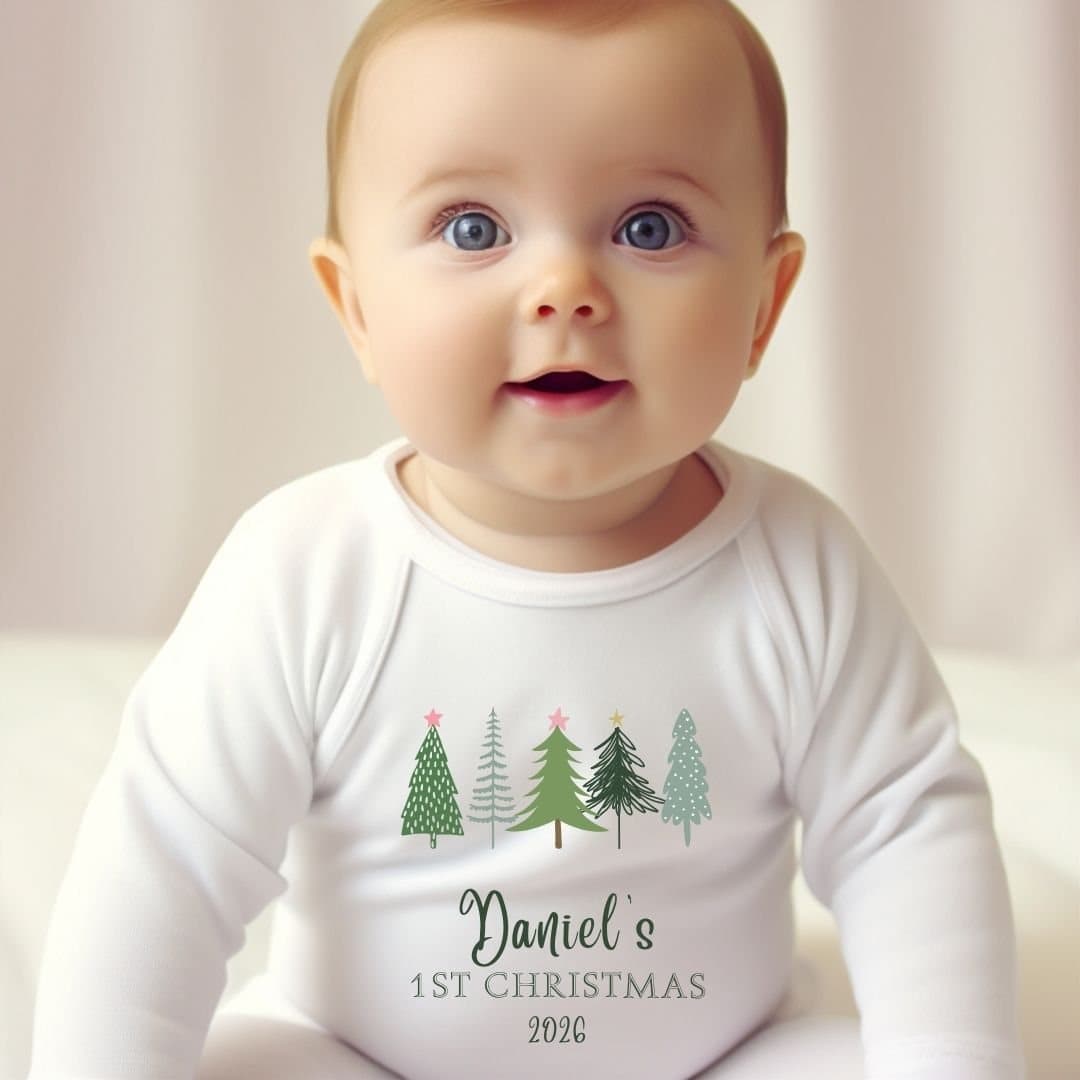 Personalised 1st Christmas babygrow with a row of fir trees and words in green