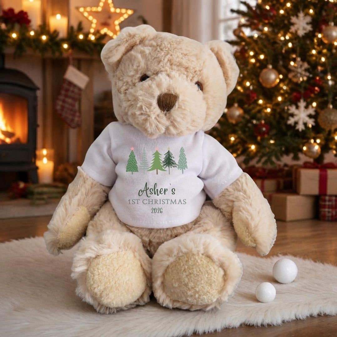 Teddy bear in a T-shirt with a row of fir trees and a name printed on it