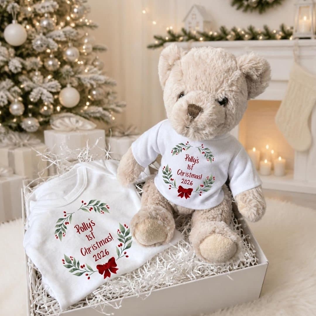 Personalised baby gift box with a teddy and a red bow vest with holly and berries