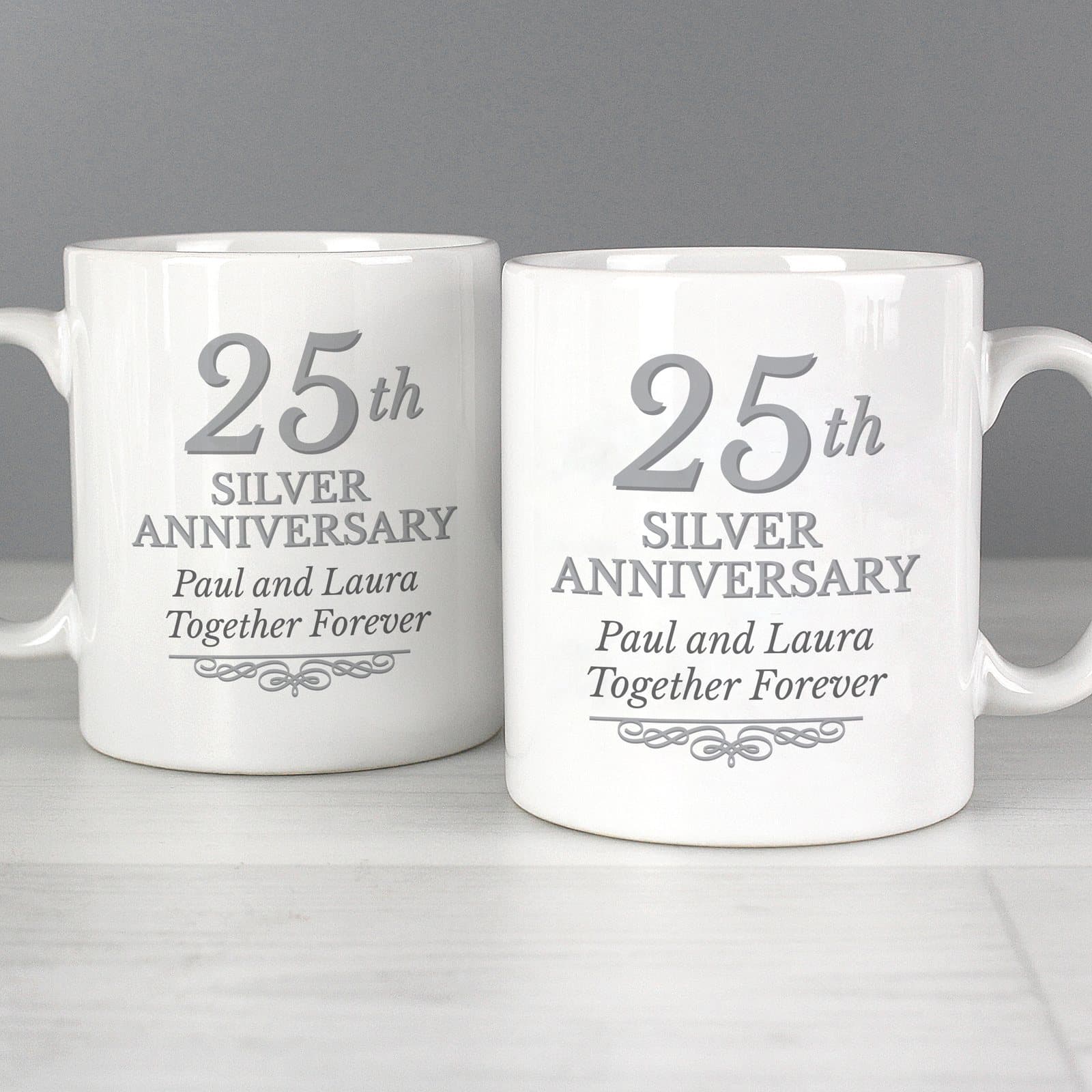 Pair of ceramic mugs with 25th Silver Anniversary text on the front