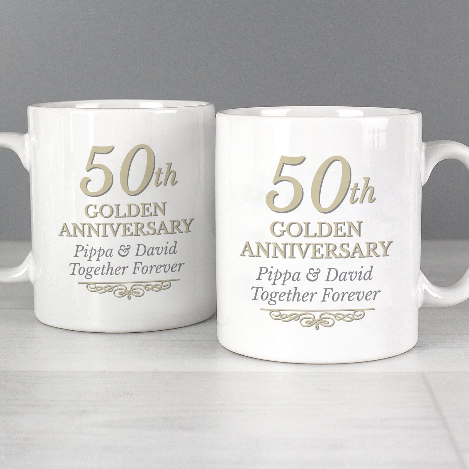 Pair of ceramic mugs with 50th Golden Anniversary text on the front