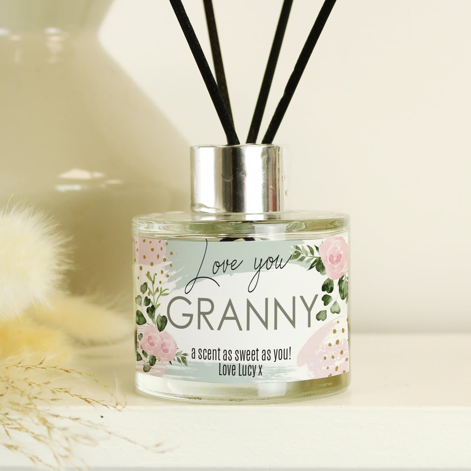 Glass reed diffuser with abstract rose design