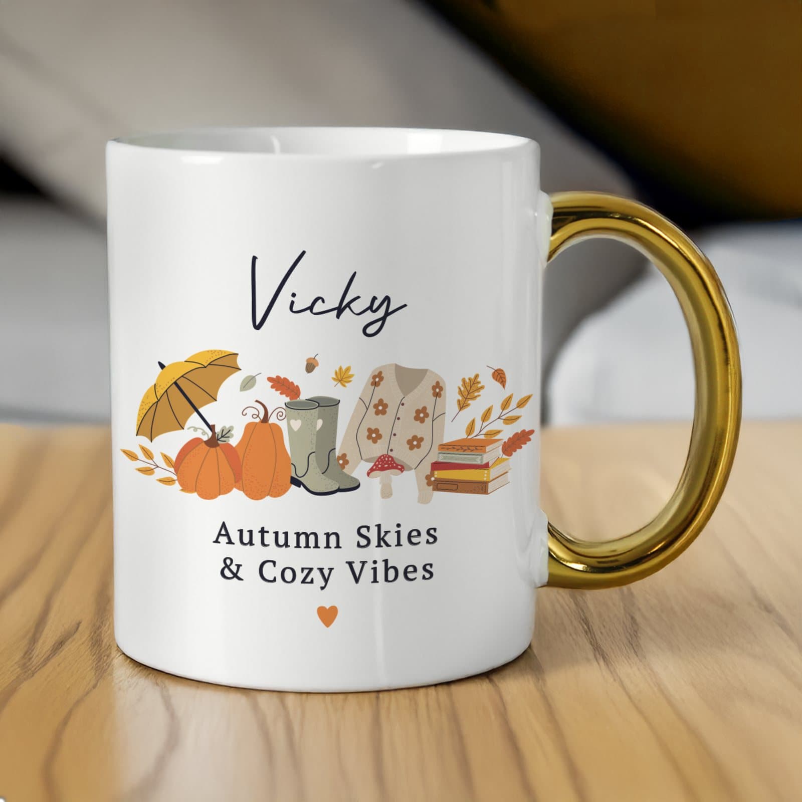 Ceramic autumn mug with illustrations, a gold handle and personalised text