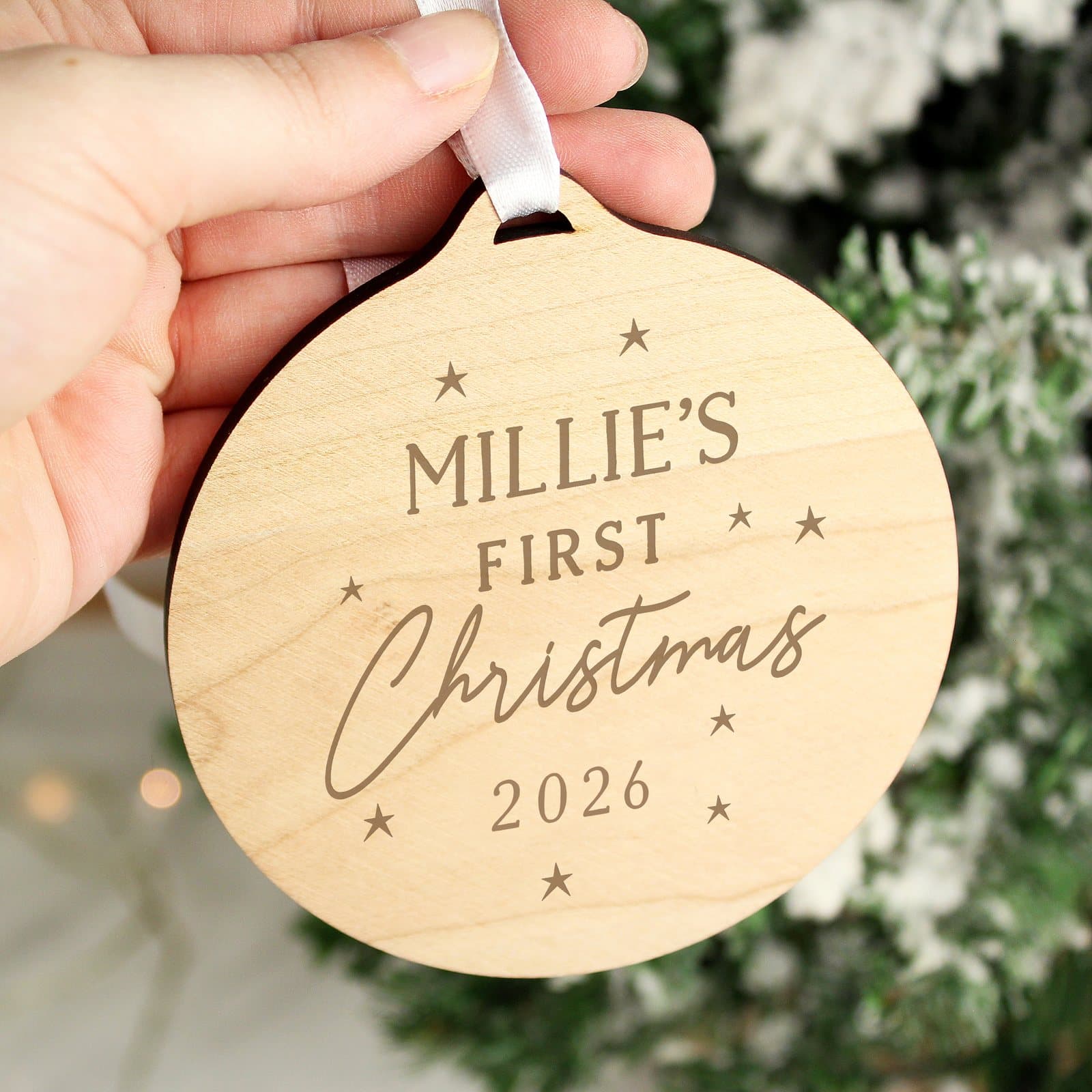 Round wooden baby's first Christmas decoration with ribbon